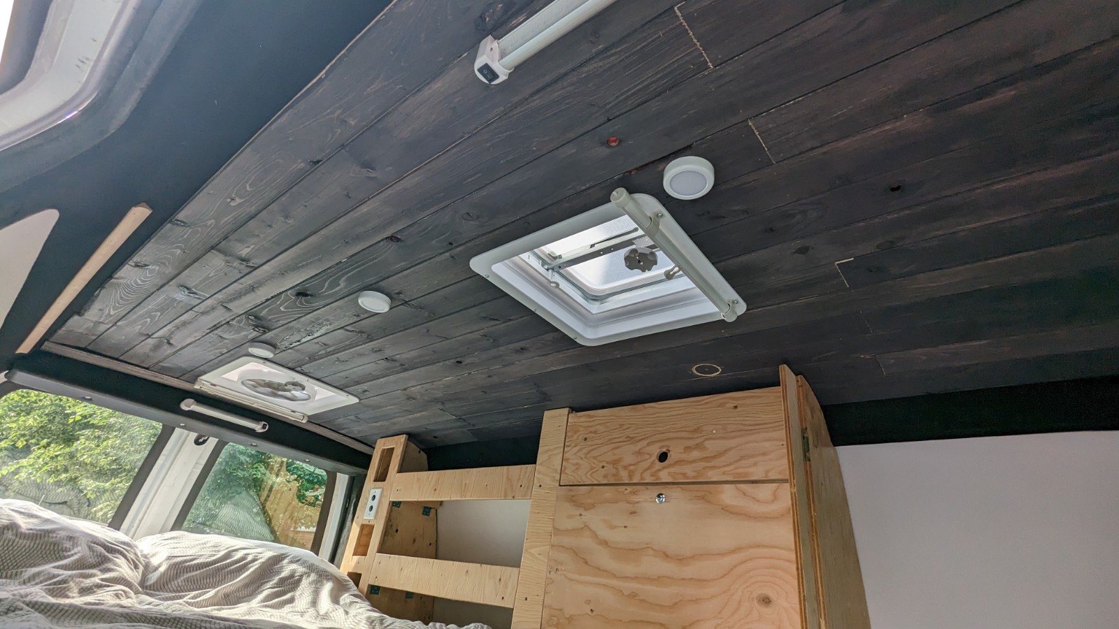 Explore this RV rental's cozy interior, featuring a dark wood plank ceiling, two vents, and built-in lighting.. Chevrolet Other 2008