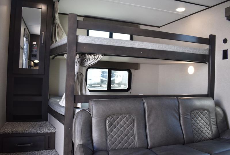 RV rental bunkhouse area: sturdy wood bunk beds, cozy sofa, and storage for a comfortable journey.. Grand Design Transcend Xplor 2020