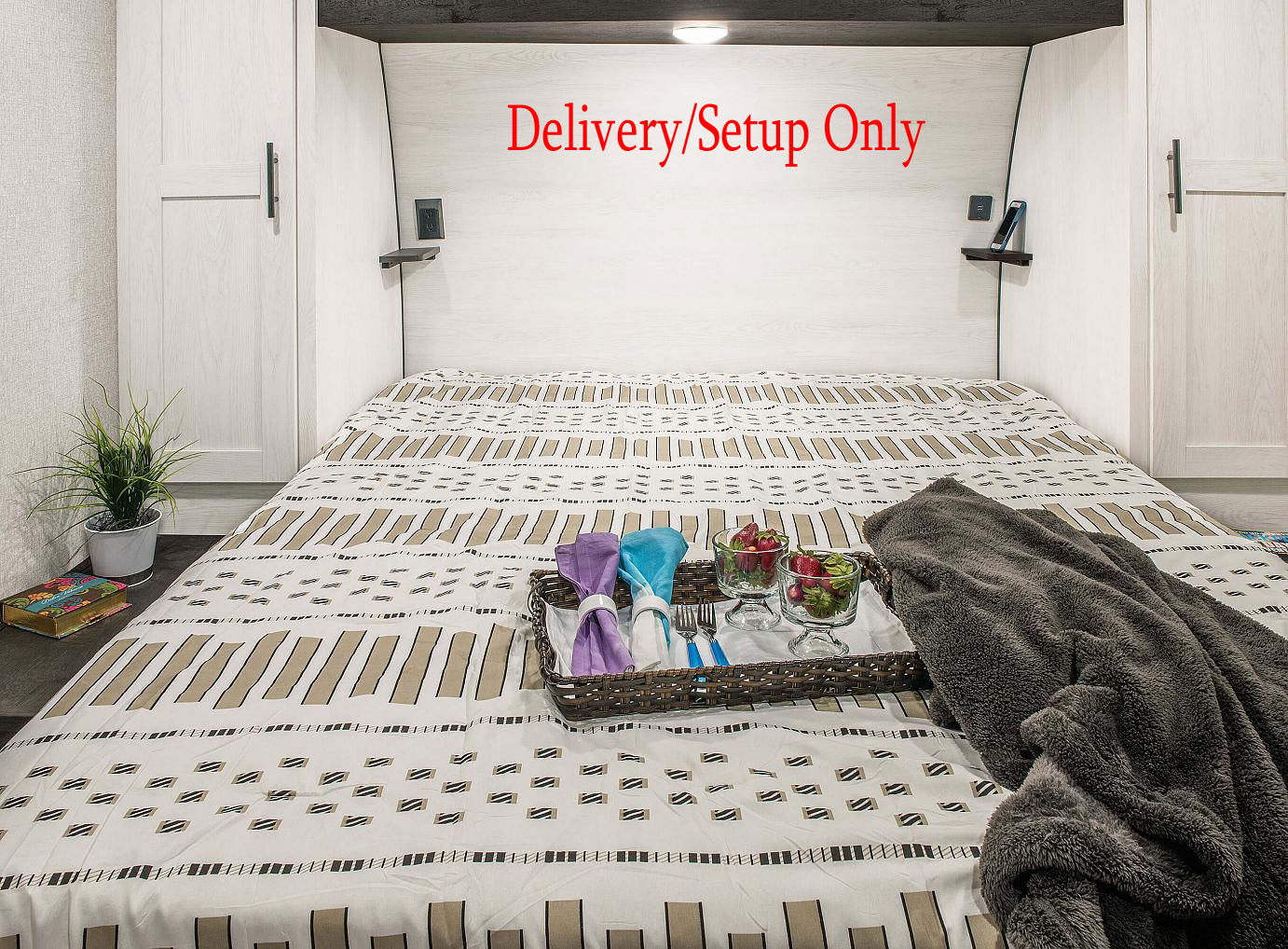 Experience a comfy RV rental bedroom: bed with patterned bedding, breakfast tray, & soft blanket. Delivery/Setup Only.. KZ 281BHSE 2022
