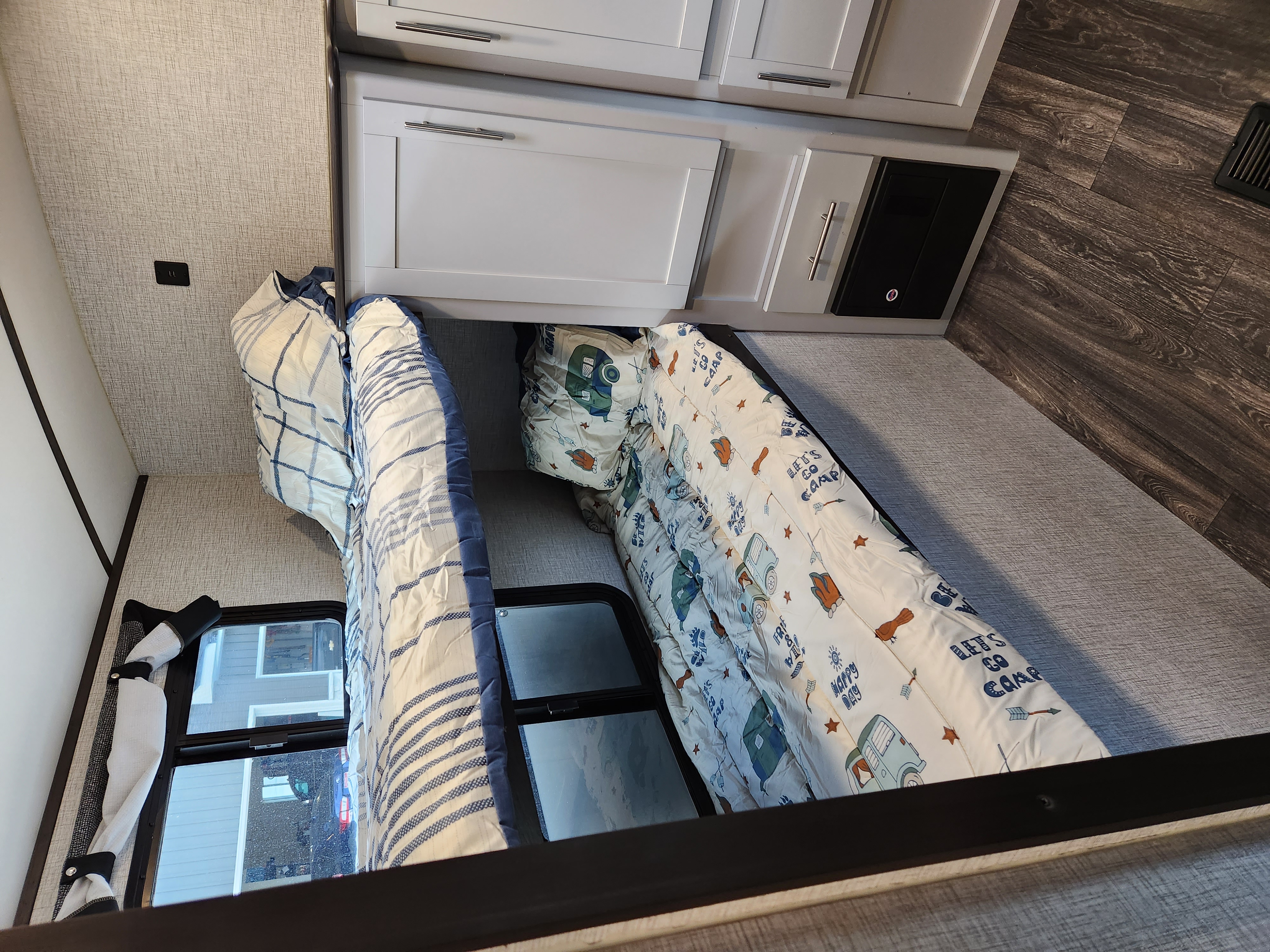 Cozy RV rental bunk beds with themed bedding & built-in storage. Ideal for family trips.. Keystone RV Bullet Ultra Lite 2021