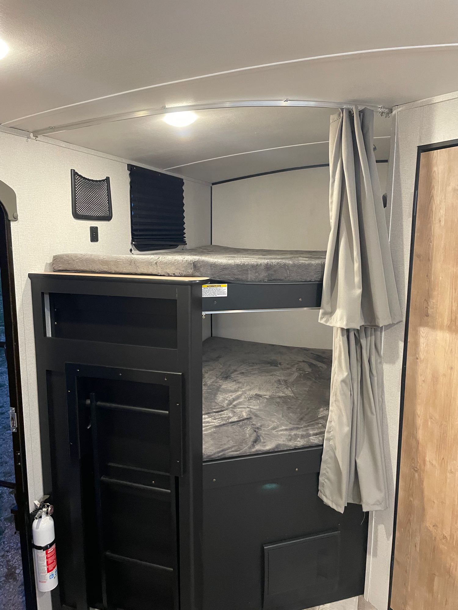 Experience comfortable bunk beds with privacy curtains in this RV rental. A compact sleeping area for your next road trip adventure.. Keystone RV Springdale 2022