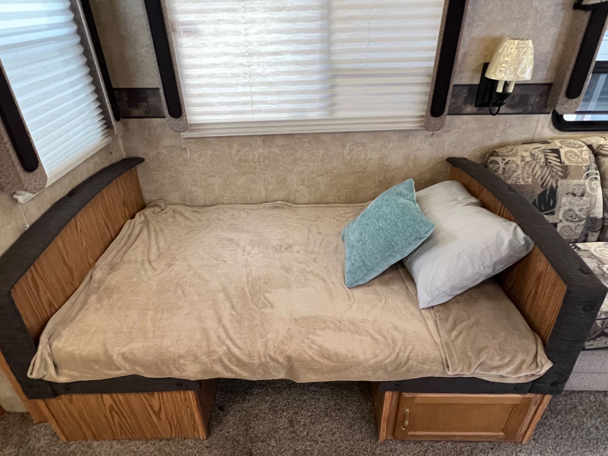 Spacious RV rental sleeping area with soft blanket, pillows, and under-bed storage for comfort.. Keystone RV Copper Canyon 2008