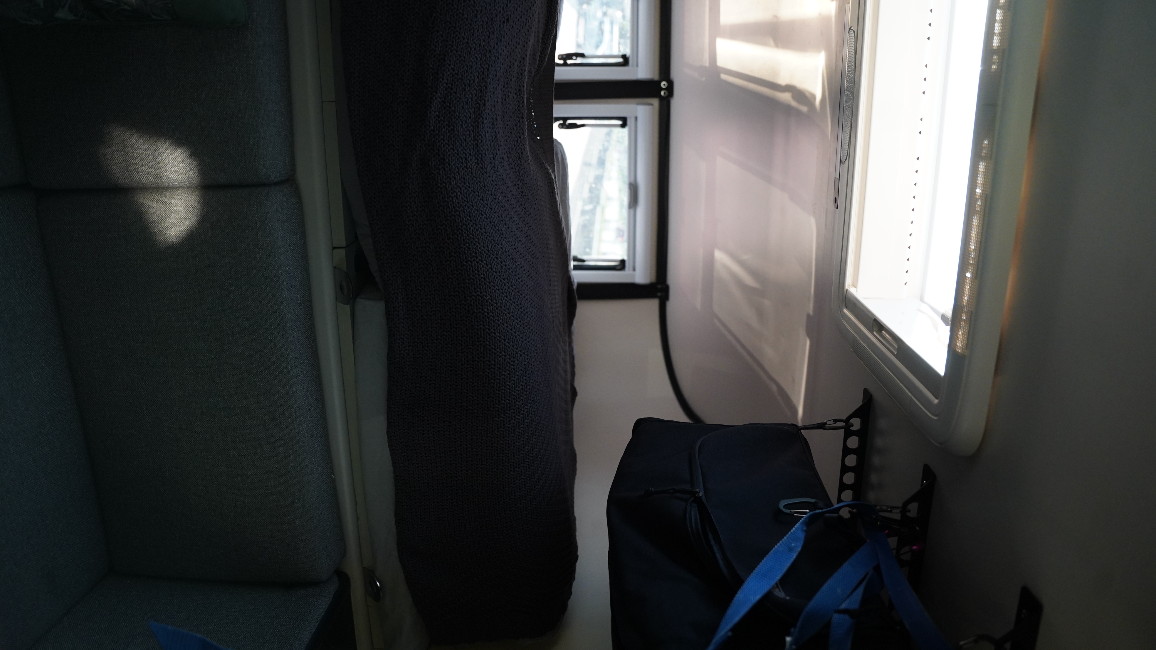 Inside an RV rental: view of the compact interior with comfortable seating, bright windows, and integrated storage.. Dodge Dodge Bighorn 3500 Heavy Duty Pu 2005