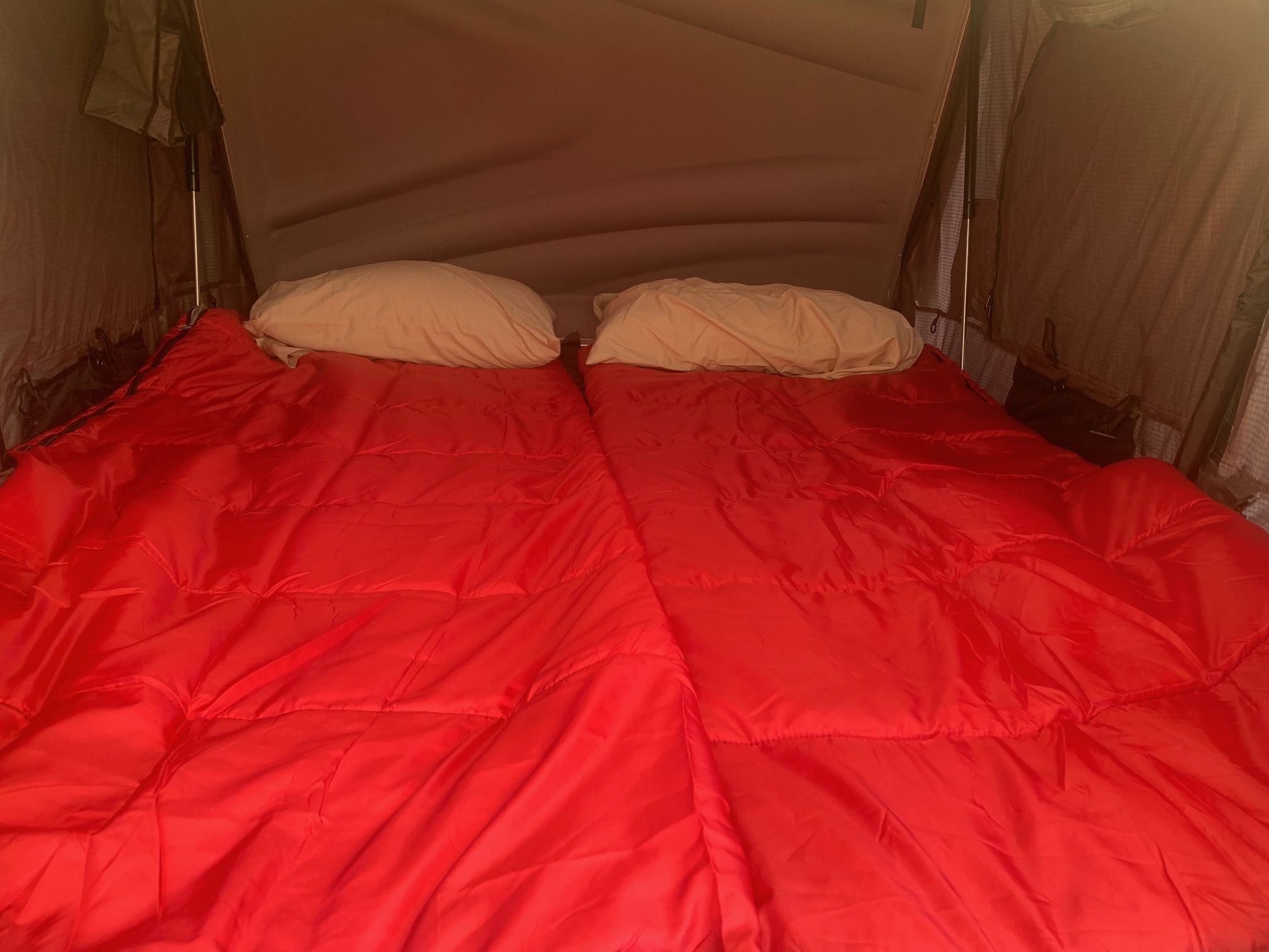 Comfortable RV rental interior: two red sleeping bags & pillows in a pop-up tent.. Toyota Toyota Land Cruiser 1995