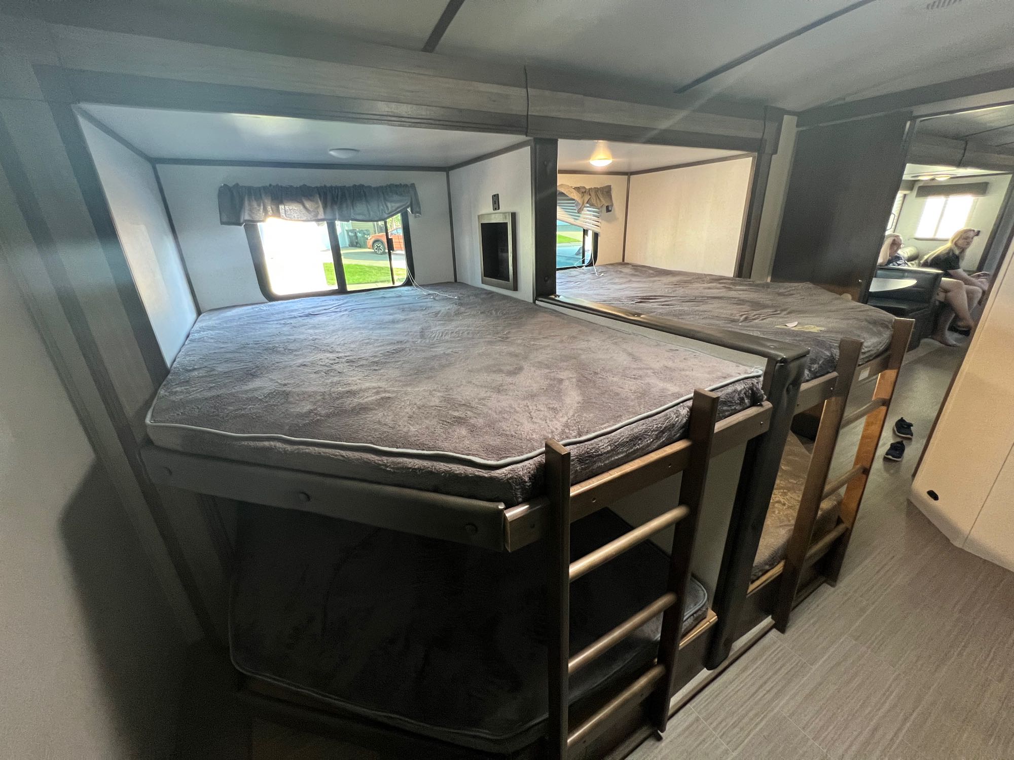 Spacious RV rental bunk room with two sets of comfy bunk beds, ideal for family camping.. Keystone Passport 2020