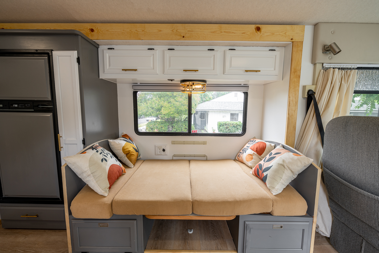 Cozy RV rental interior with convertible dinette bed, ample storage, and scenic window views.. Winnebago Sightseer 2006