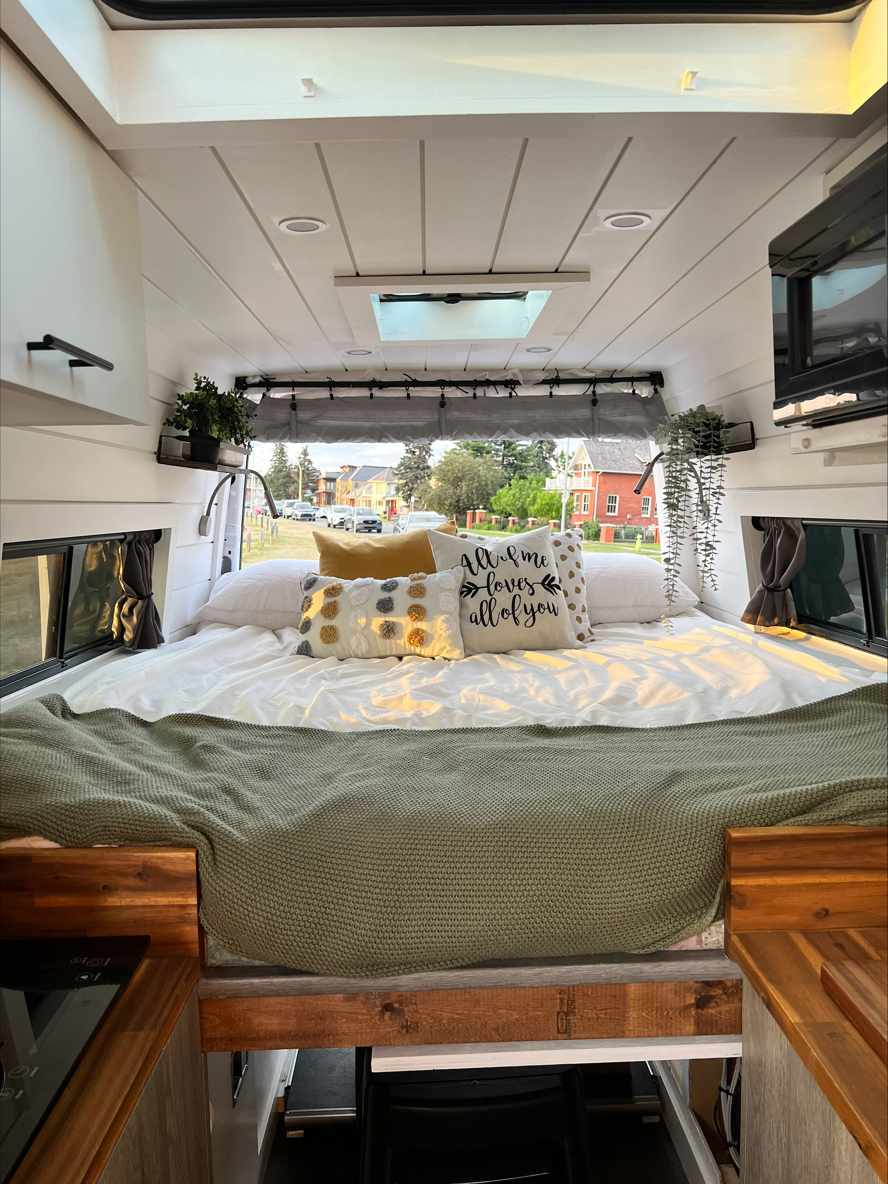 Experience cozy van life! This rv rental features a comfortable bed, skylight, and outdoor views, perfect for mobile living adventures.. Mercedes-Benz Sprinter 2012