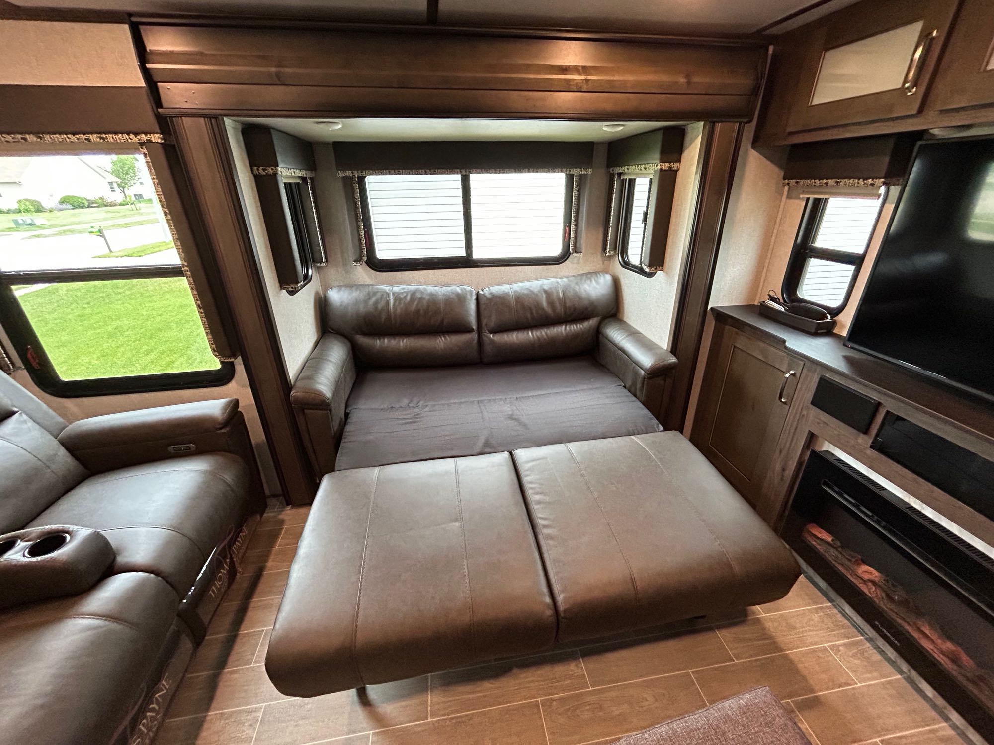 RV rental: Spacious living area with convertible sofa bed, recliners, entertainment center, and fireplace.. Keystone RV Montana High Country 2019