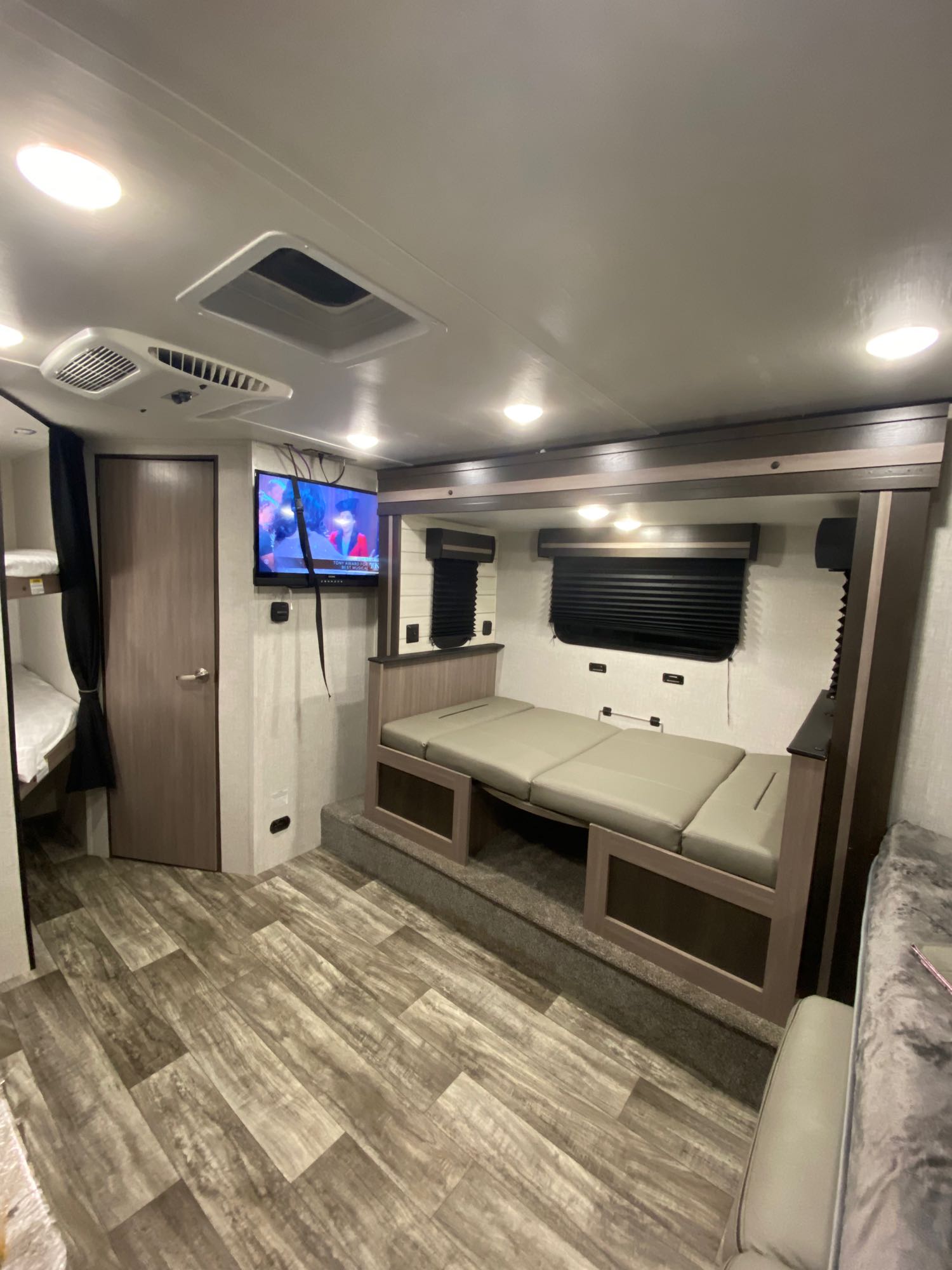 Step inside this modern RV rental! View the inviting dinette, mounted TV, and convenient bunk beds in this well-appointed interior.. Crossroads Rv Sunset Trail Super Lite SS188BH 2022