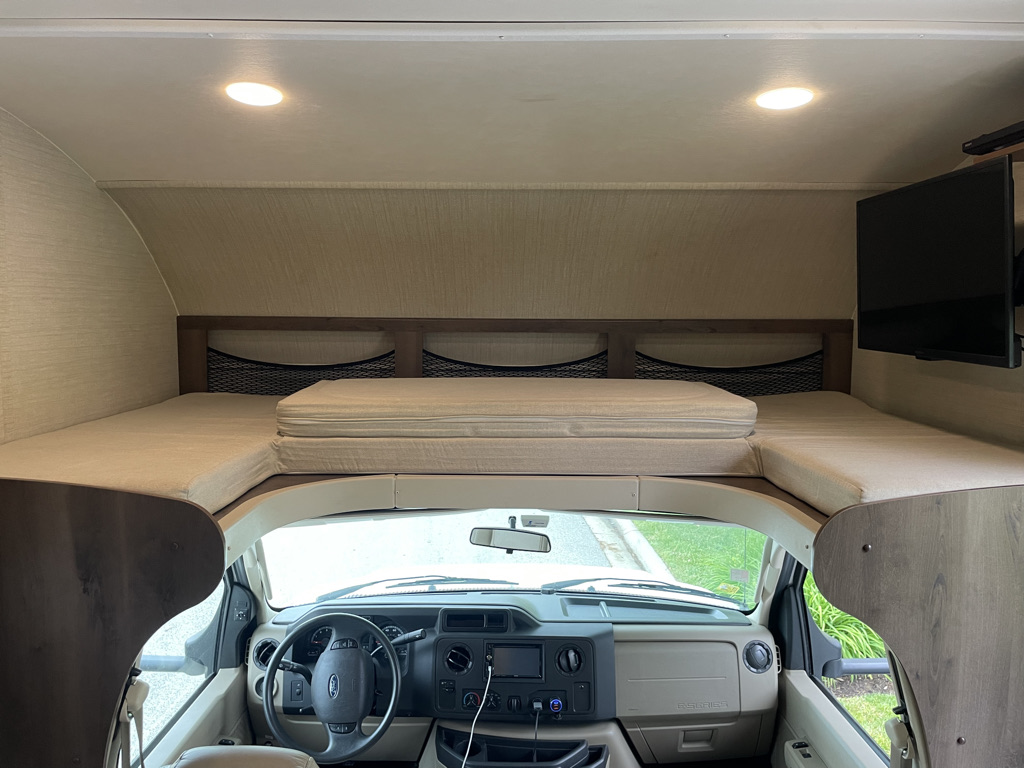 This clean RV rental features a cozy over-cab bunk bed, mounted TV, and driver's cabin, ready for your next adventure.. Jayco Redhawk 2018