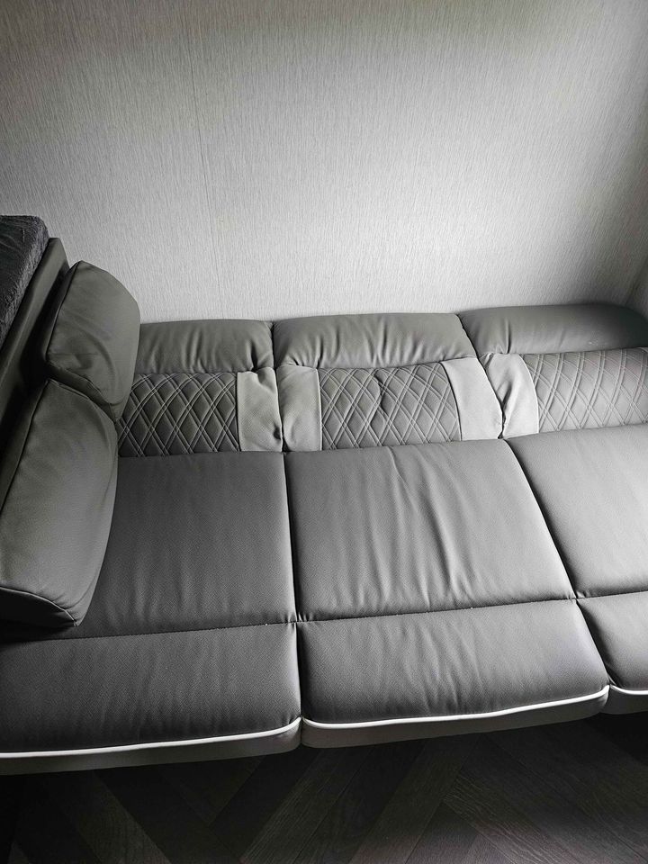 Gray quilted sofa/bed in a modern RV rental. Features comfortable seating & a versatile sleeping area.. Forest River Salem Cruise Lite 2022