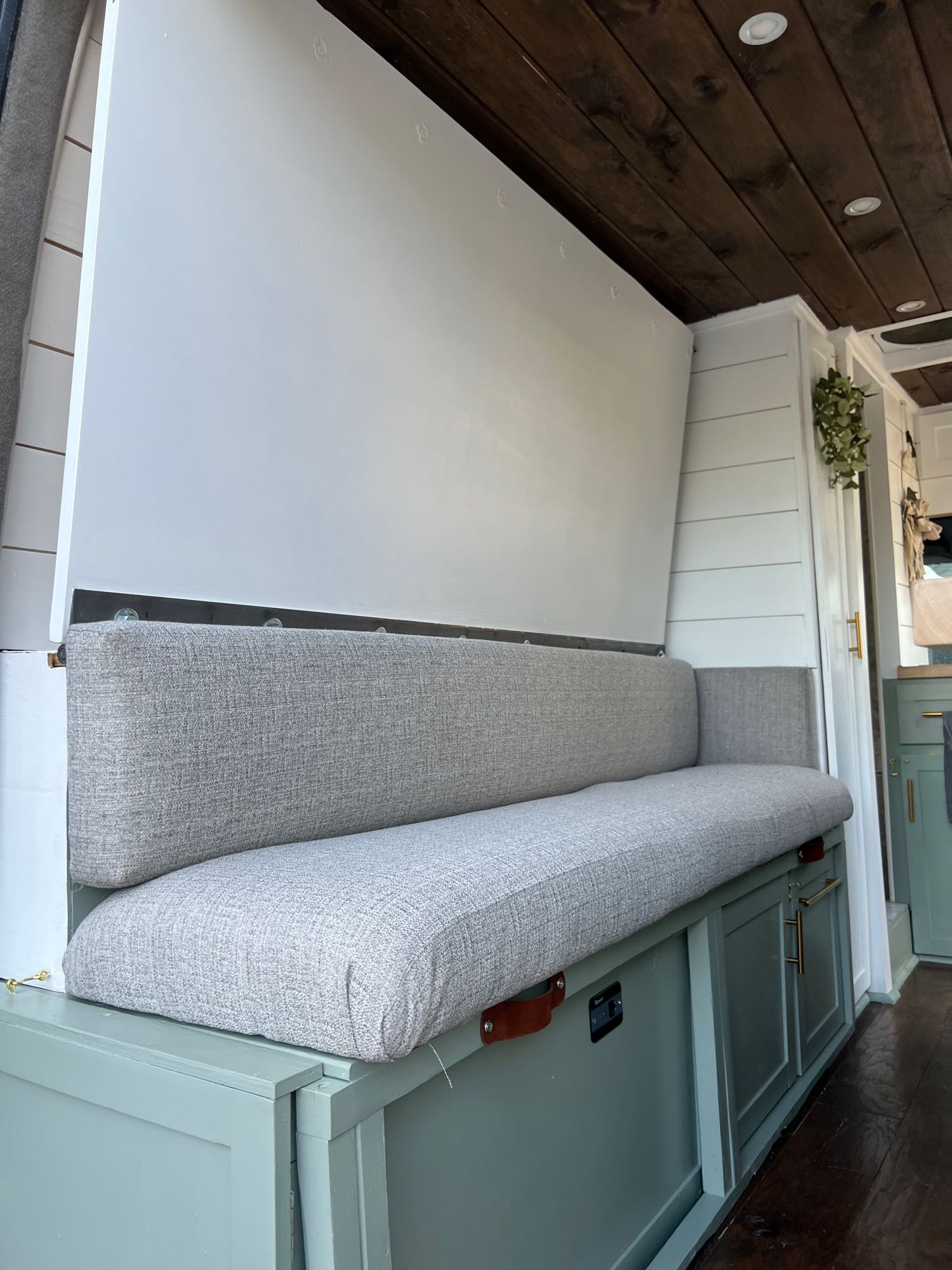 Spacious RV rental interior with convertible bench seating, ample storage, and warm wooden ceiling.. Mercedes Sprinter 2012