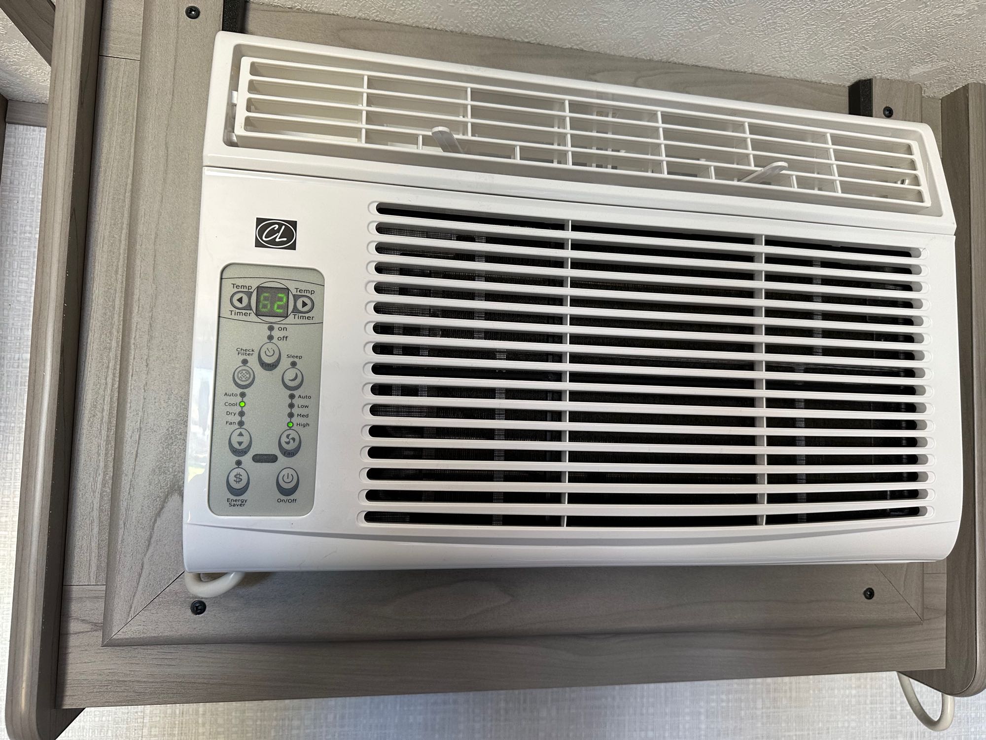 An RV rental's built-in air conditioner, displaying a temperature setting of 62 degrees, with various digital controls.. Coleman Lantern LT 17B 2023