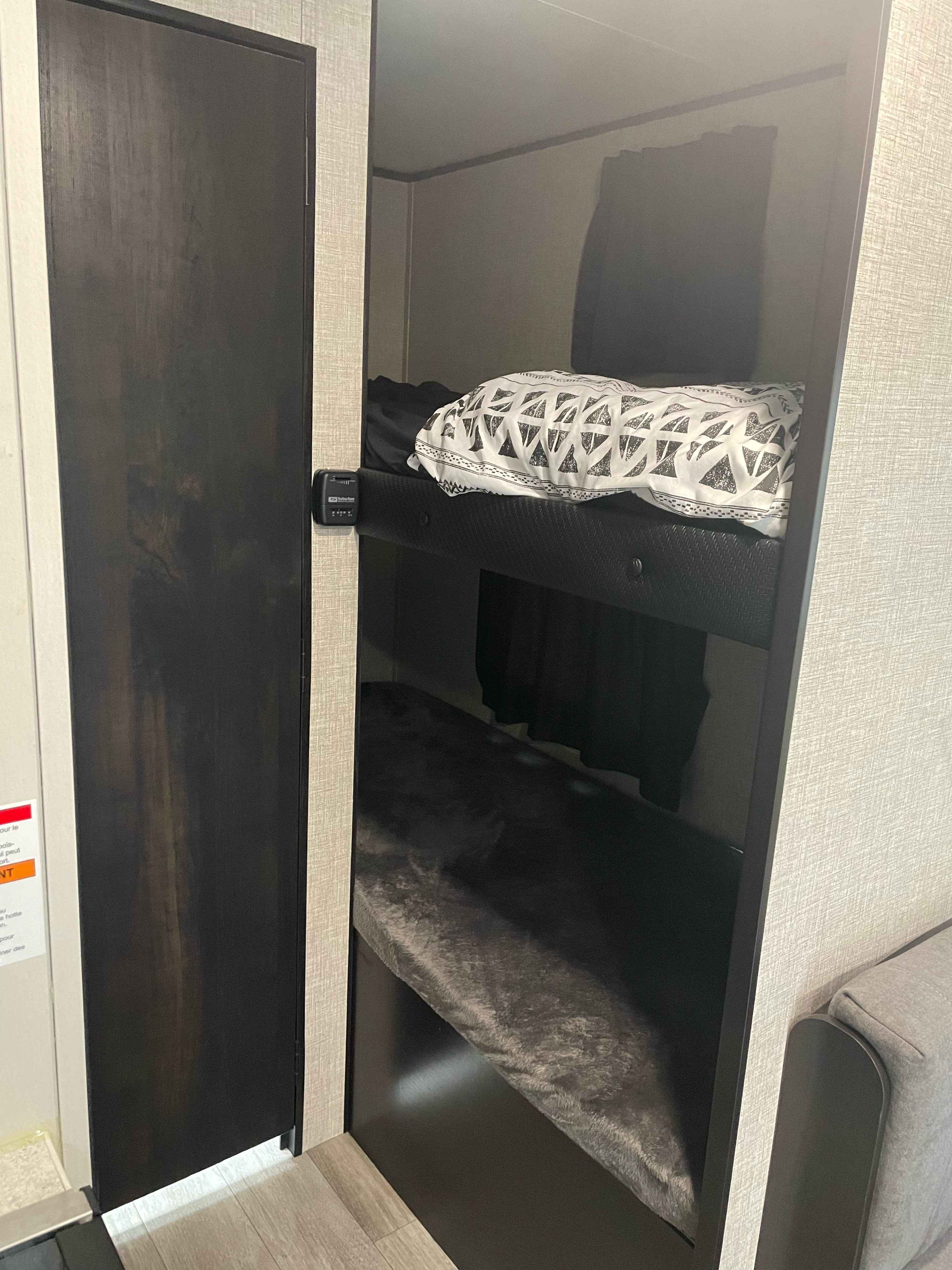 RV rental interior featuring cozy dark bunk beds with bedding, ideal for compact sleeping arrangements.. Jayco Jay Flight SLX 2022