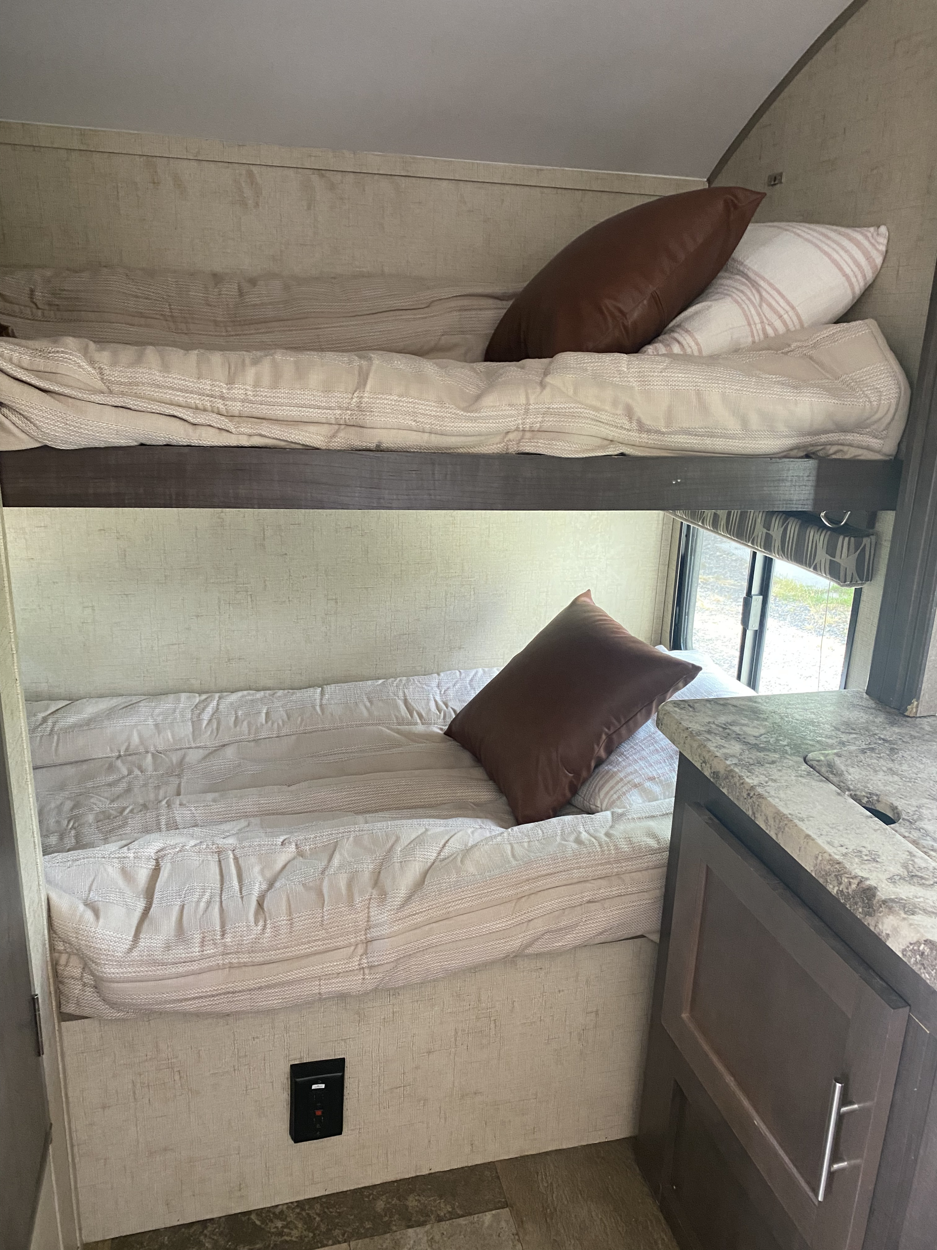 Cozy RV rental interior featuring two bunk beds, a perfect sleeping area for your next camper adventure.. Forest River Rpod-182G 2016