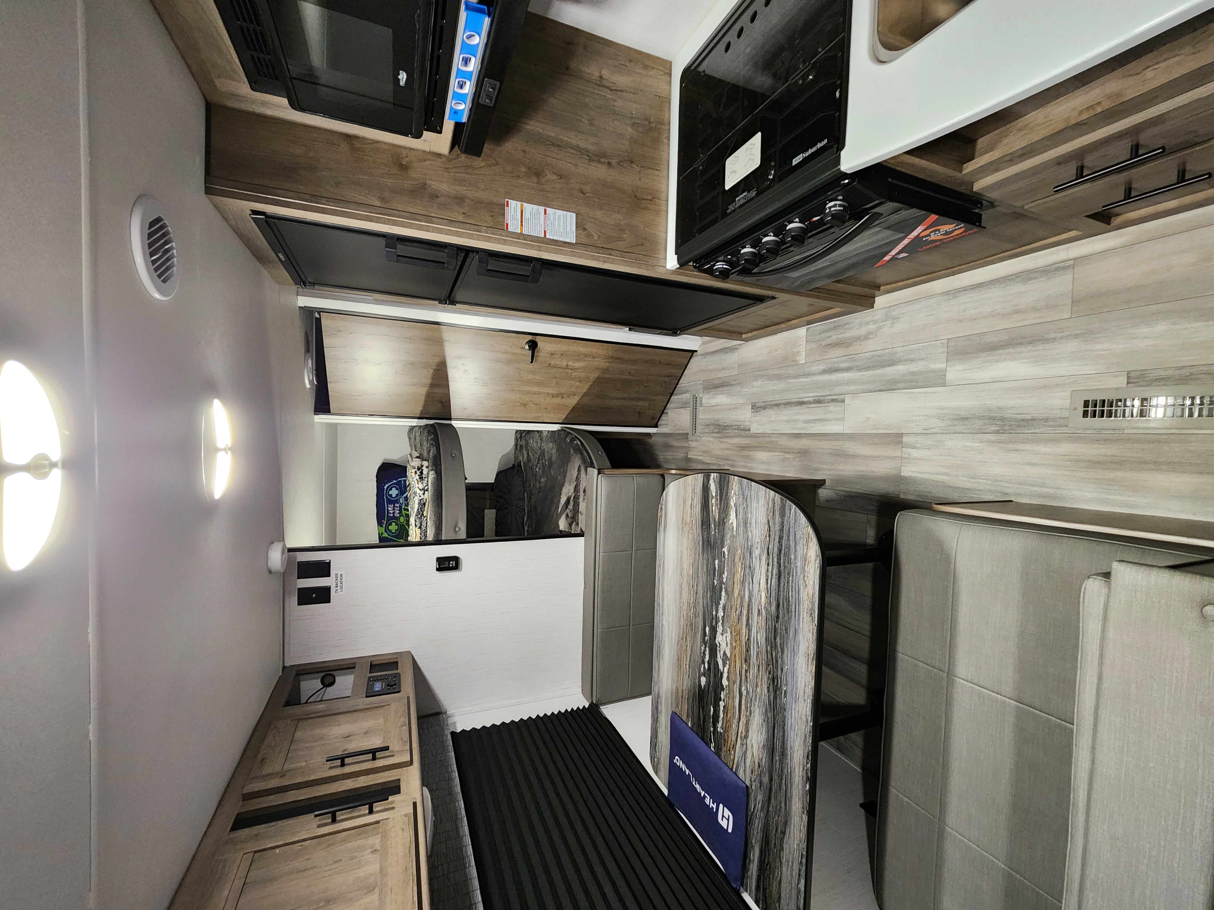 This RV rental showcases a modern, light-filled interior with a kitchen, dinette, and ample storage, ideal for travelers.. Heartland RV Pioneer 2023