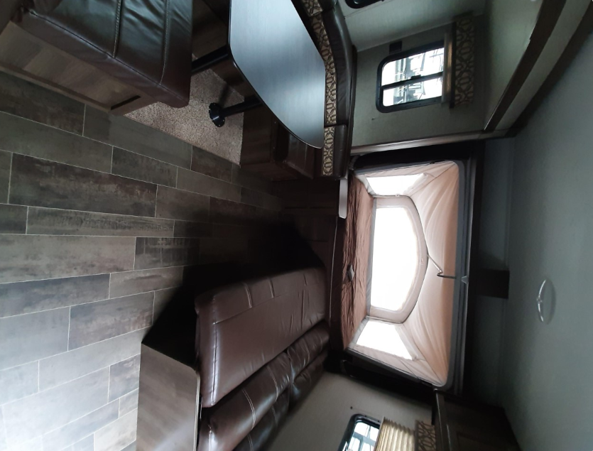 RV rental: Spacious interior with wood-look flooring, dinette, sofa, and comfortable expandable bed area.. Keystone RV Bullet Crossfire 2018