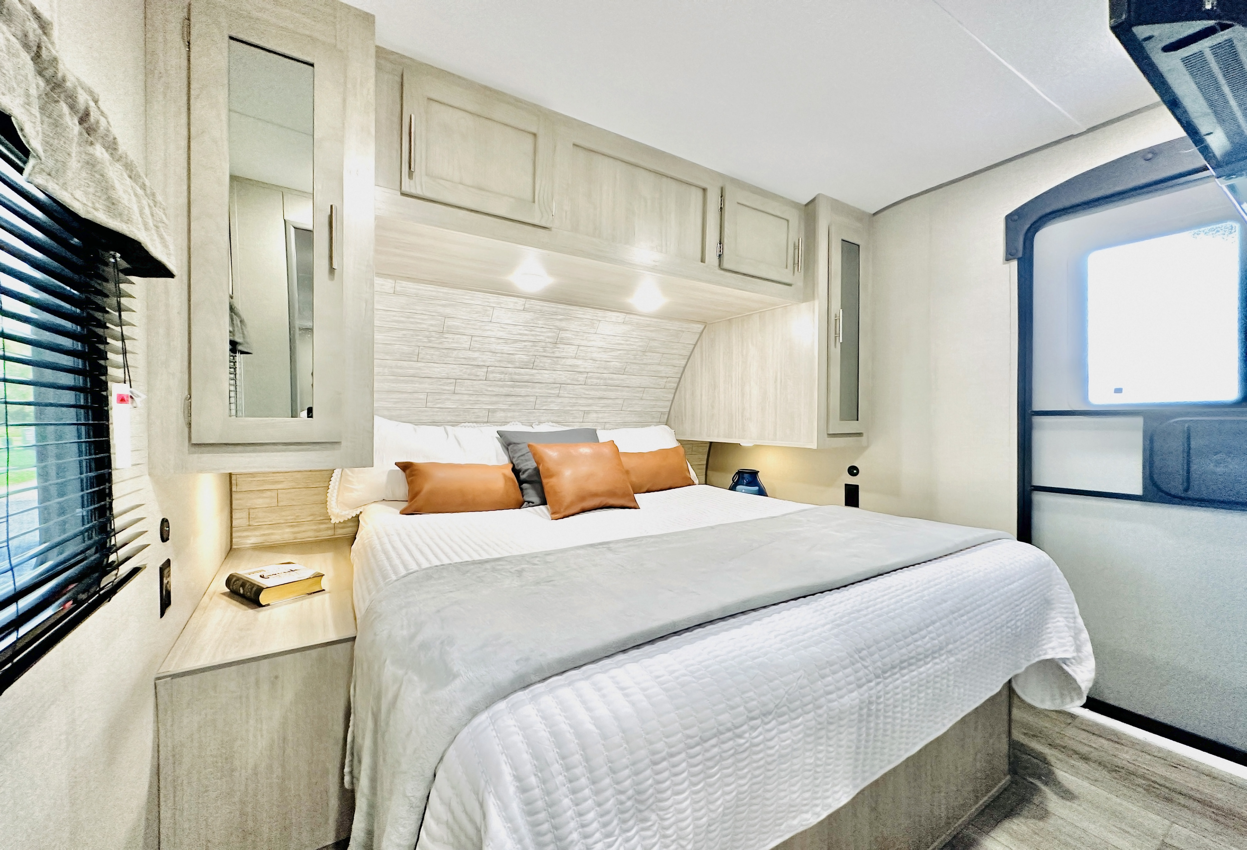 Cozy RV rental bedroom with a comfortable bed, built-in storage, and modern finishes. Ideal for travel.. Forest River Coachmen Catalina Legacy 2023