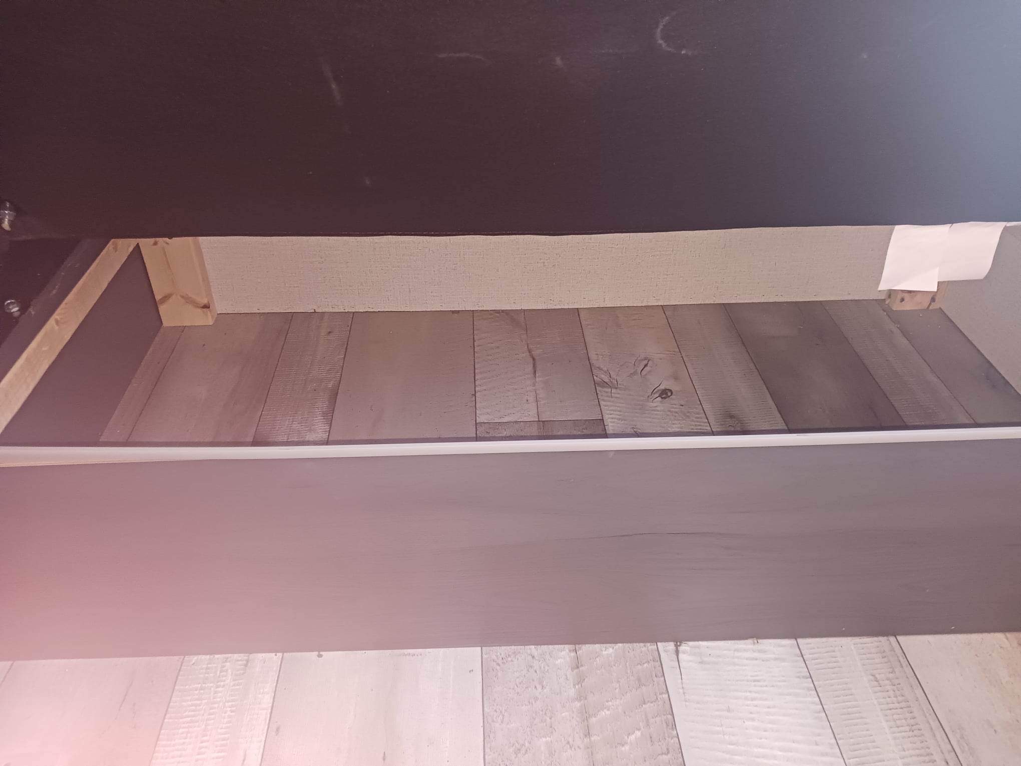 Inside an RV rental, the under-bed storage reveals wooden supports and plank flooring.. Aspen Trail LE 2022