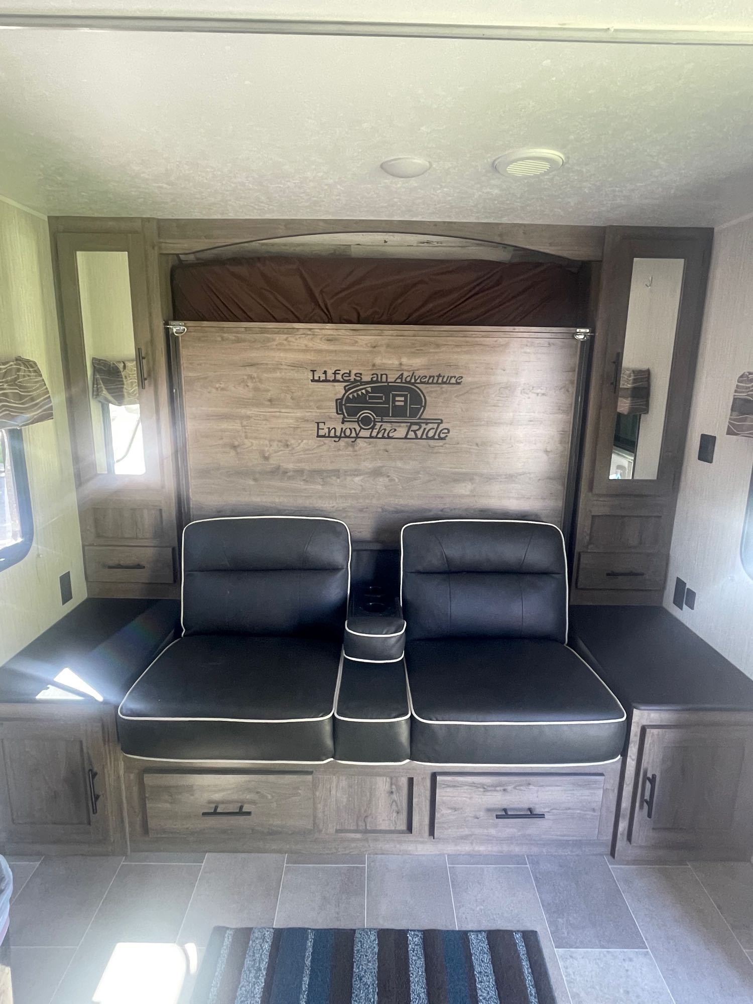 This RV rental's interior features a space-saving murphy bed, comfortable seating, and ample storage for your journey.. Palomino Palomino puma xle lite 23fbc 2020