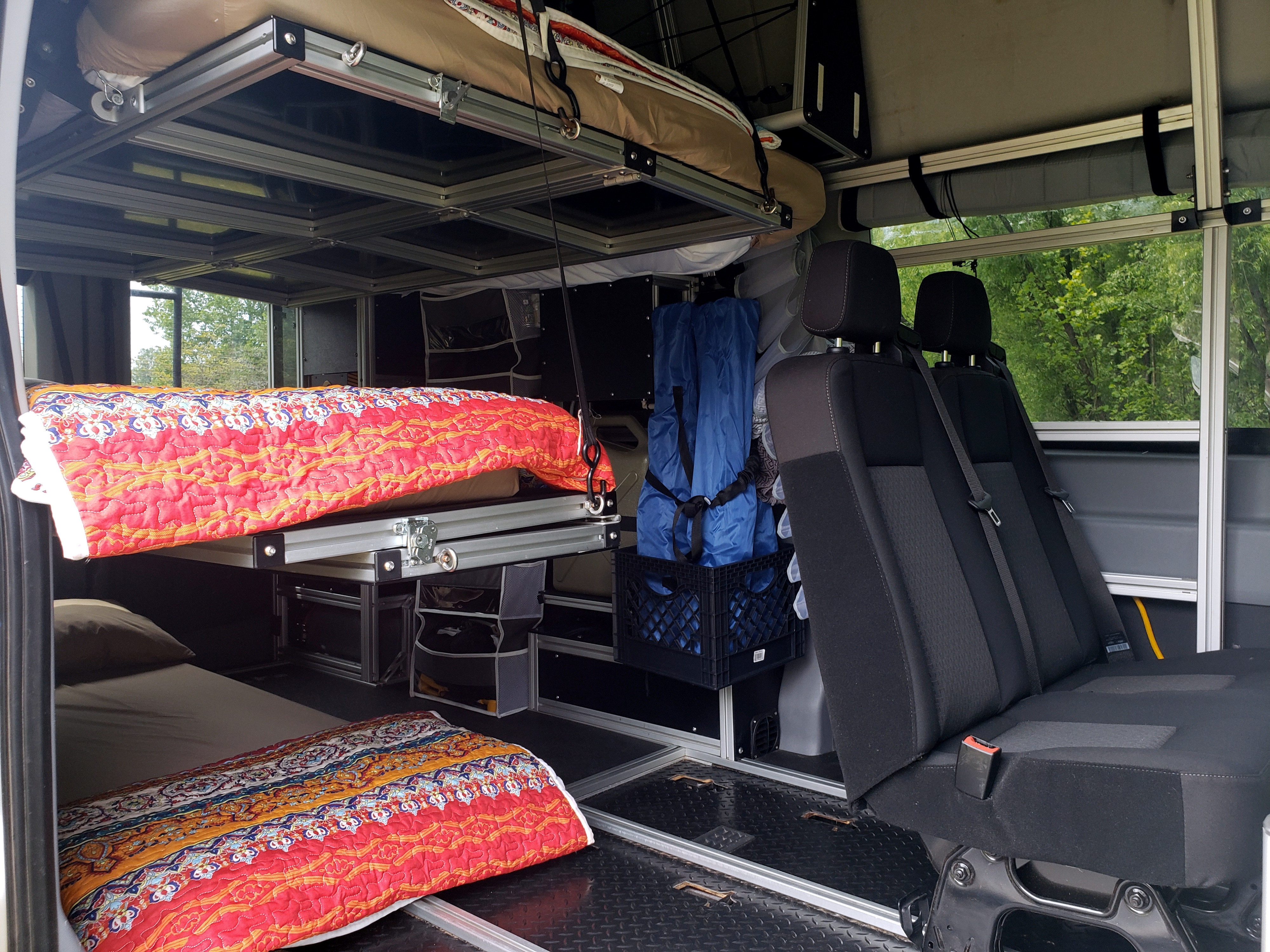 Versatile rv rental interior with bunk beds & modular design, providing compact sleeping and seating for travelers.. Ford Transit 2019