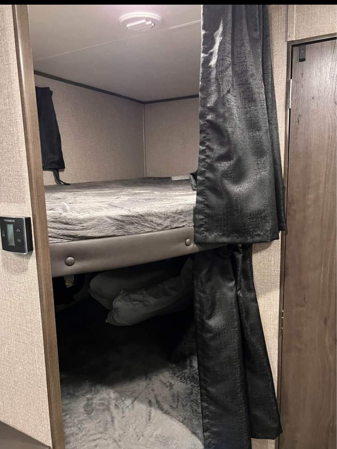 This RV rental features a cozy bunk bed area with privacy curtains for comfortable sleeping space.. Jayco Jay Flight SLX 2021