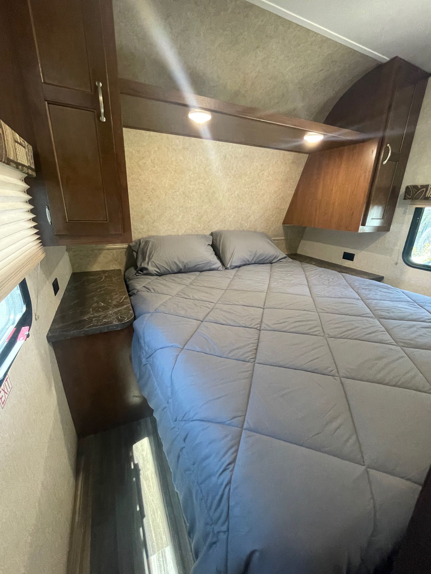Discover this clean rv rental bedroom. Features a comfy bed, overhead storage, and bedside counters for your next adventure.. Jayco Jay Flight SLX 2017