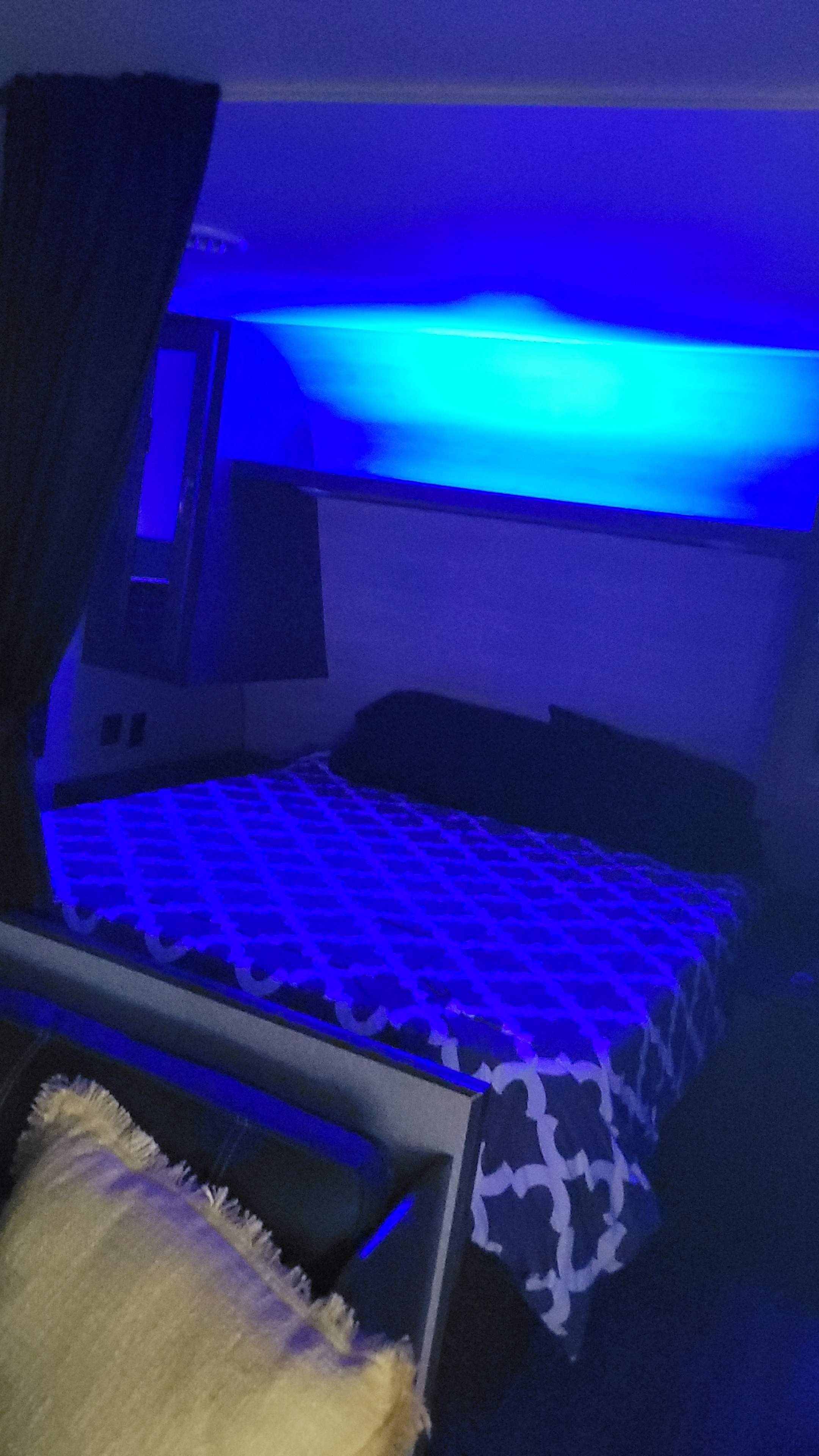 Cozy RV rental bedroom with vibrant blue ambient lighting and a patterned bed, offering a relaxing retreat.. Jayco Jay Flight SLX 2021