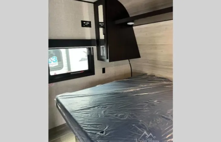 RV rental: Cozy bedroom with a protected bed, integrated cabinet with light, and window. Perfect for your next adventure.. Jayco Jay Flight 2022