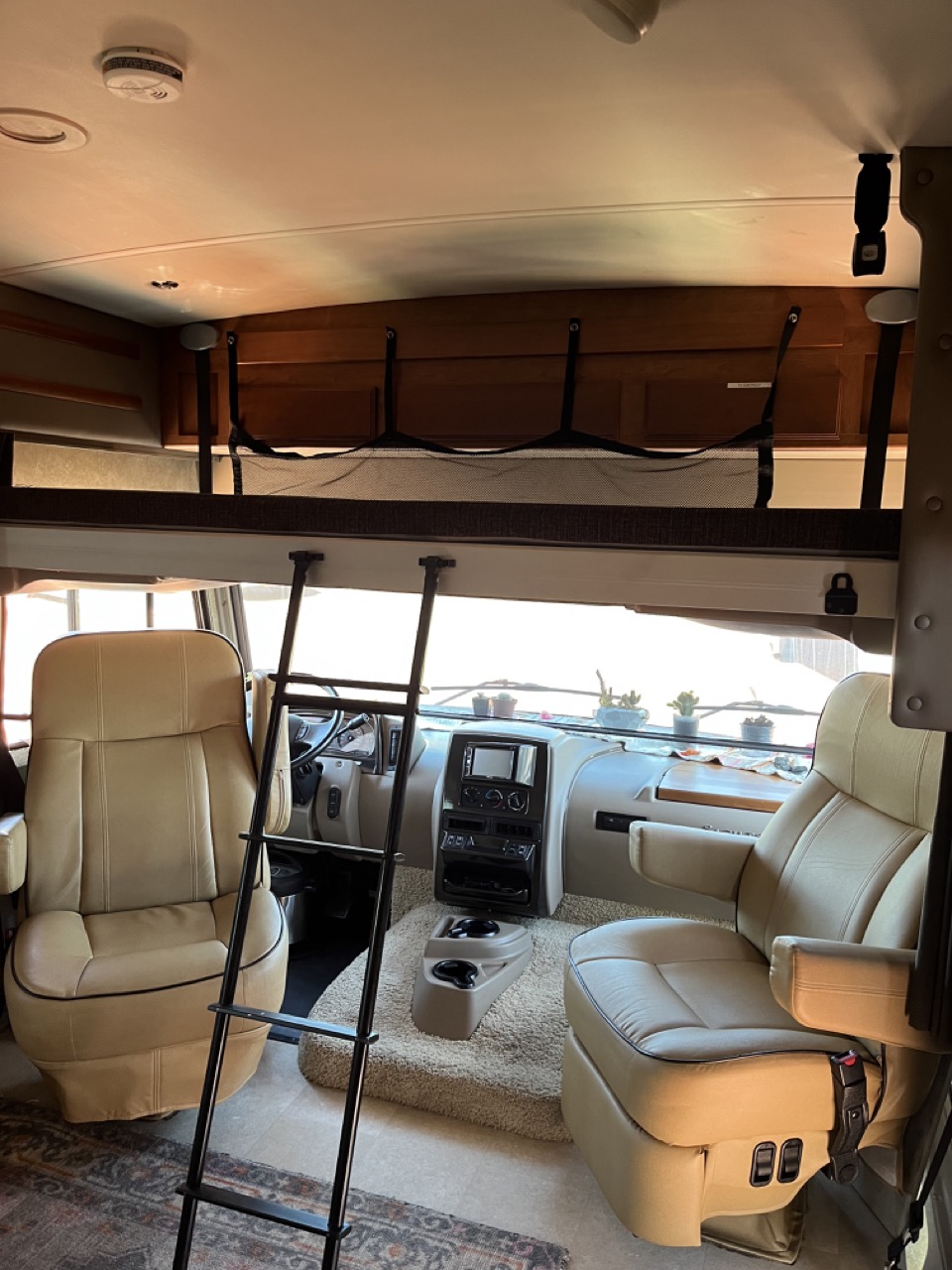 A full size bunk lowers from above the captain chairs up front.. Winnebago Sightseer 2017