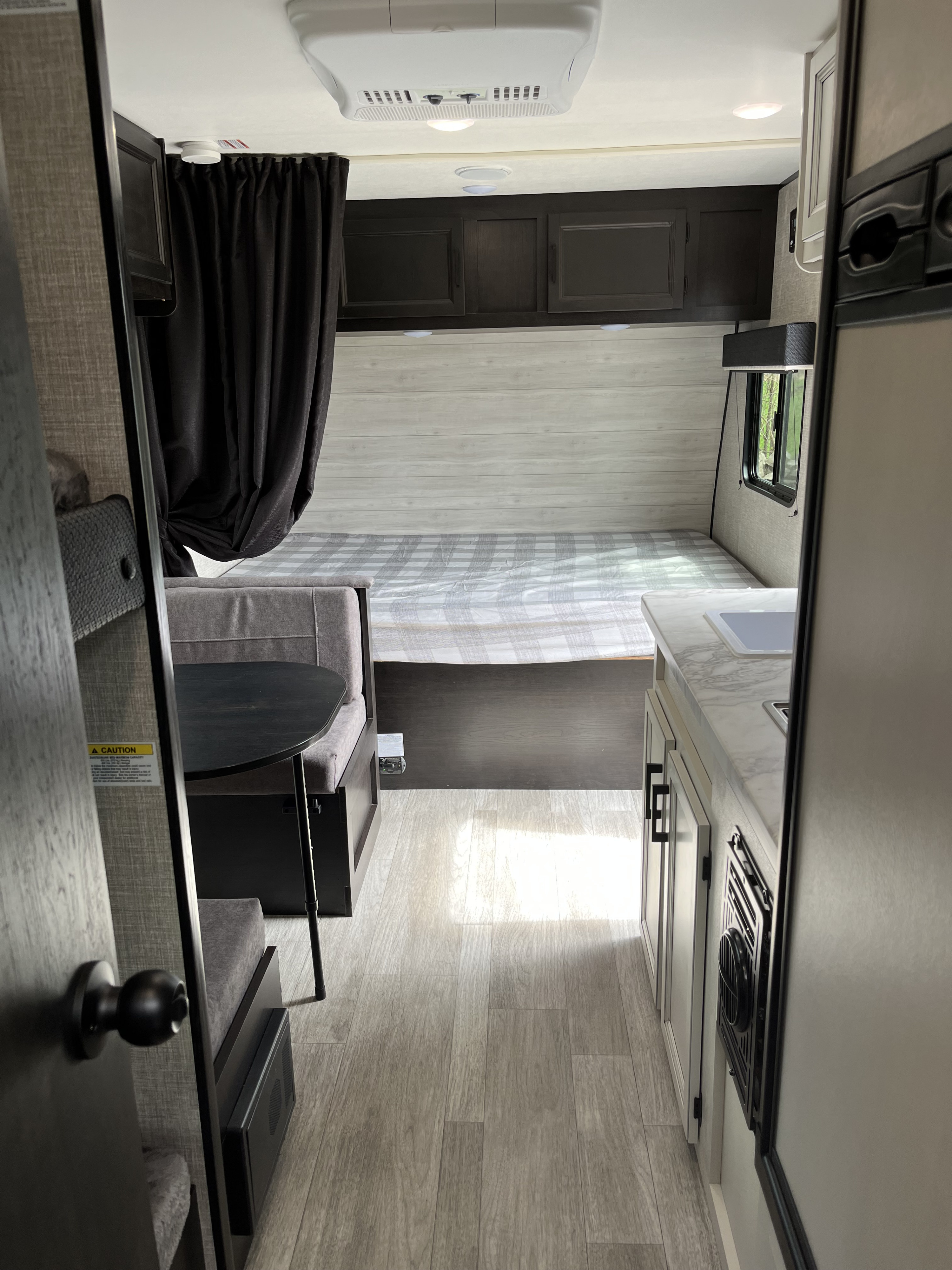 Modern RV rental interior featuring a bed, dinette, and kitchen for comfortable travel adventures.. Jayco Jay Flight SLX 2022