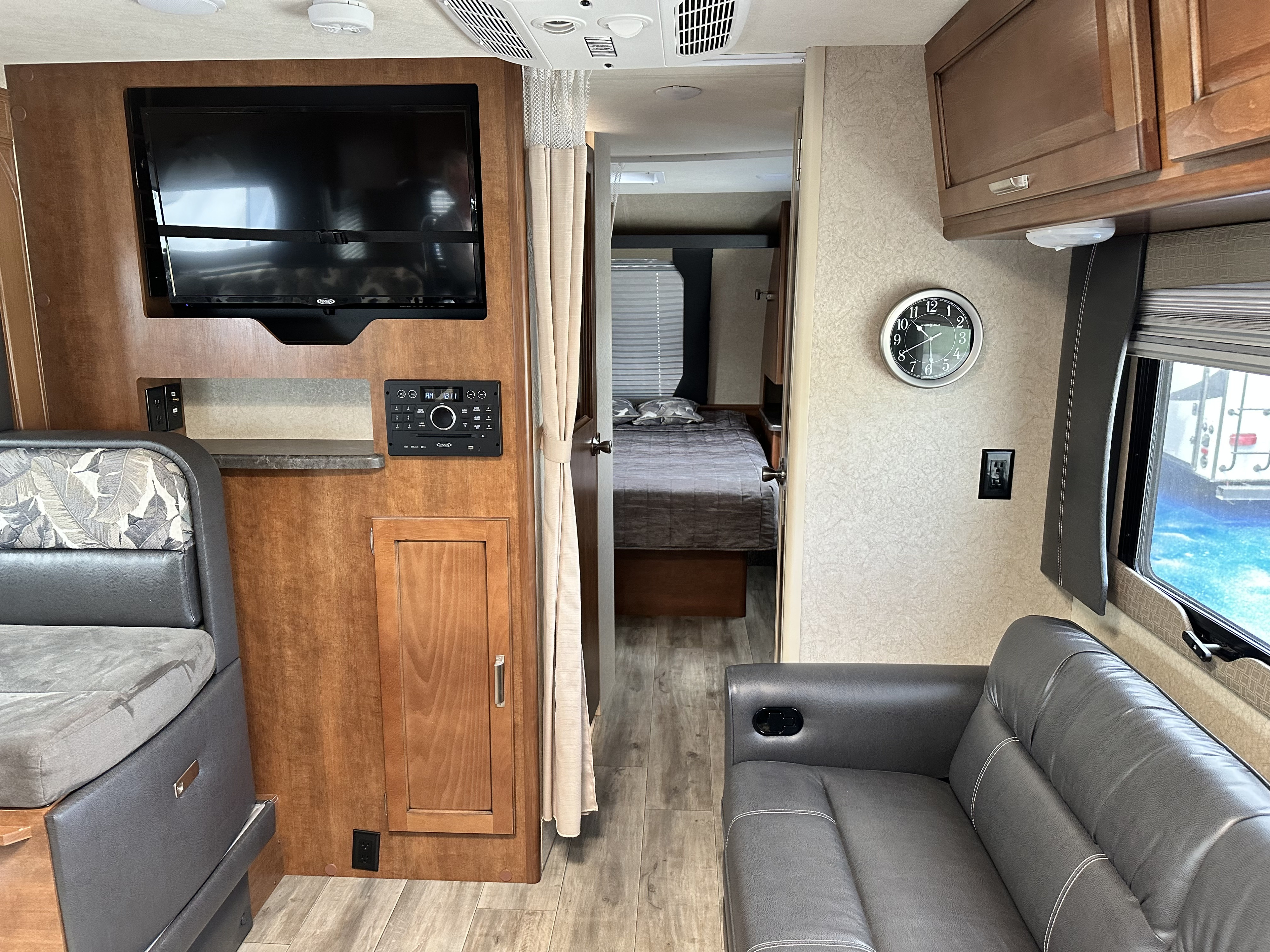 Inside this clean RV rental: comfy dinette, flat-screen TV, and bedroom. A great space for travels!. Lance Manufacturing Lance Manufacturing Trailer 2018