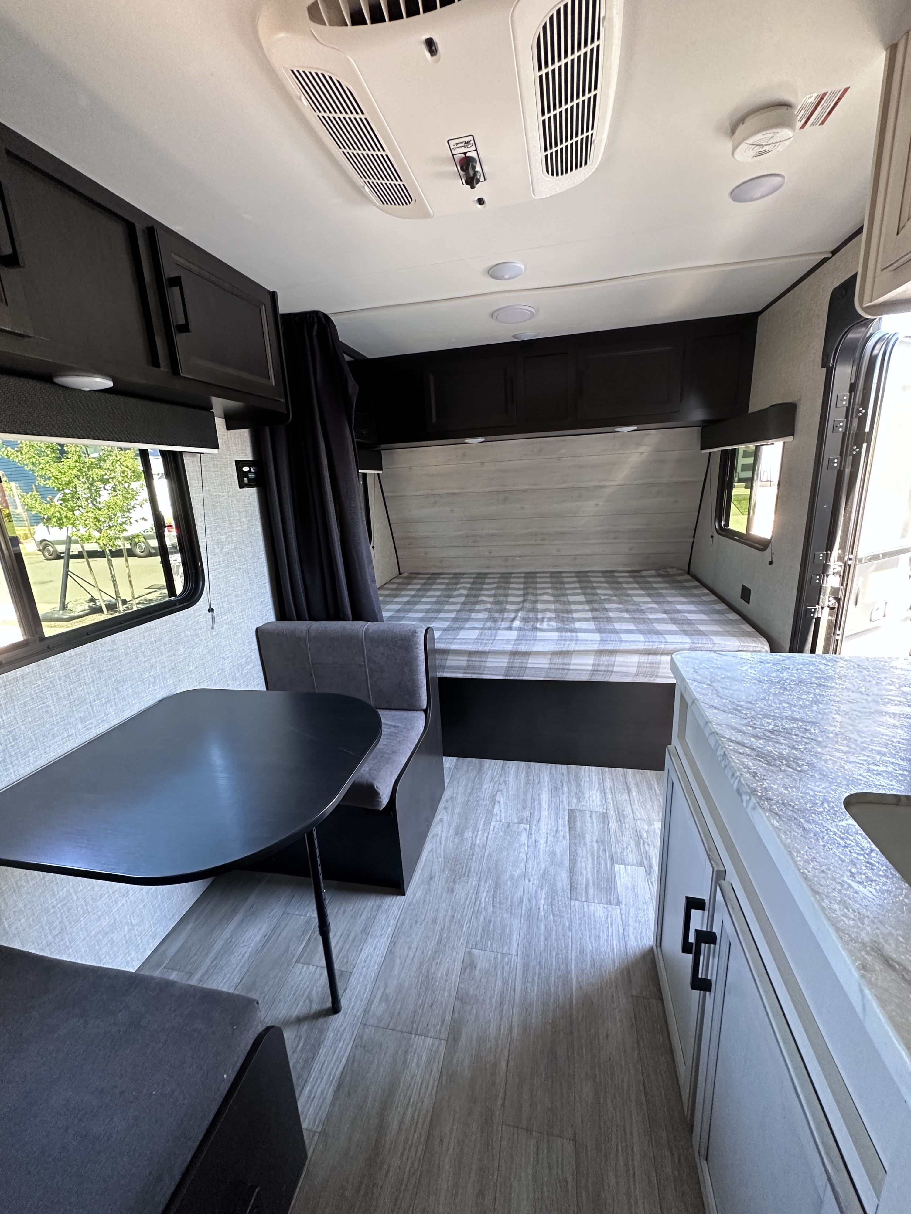 Spacious rv rental interior featuring a cozy bed, dinette, and compact kitchen. Perfect for your next adventure.. Jayco Jay Flight SLX Baja Edition 2022
