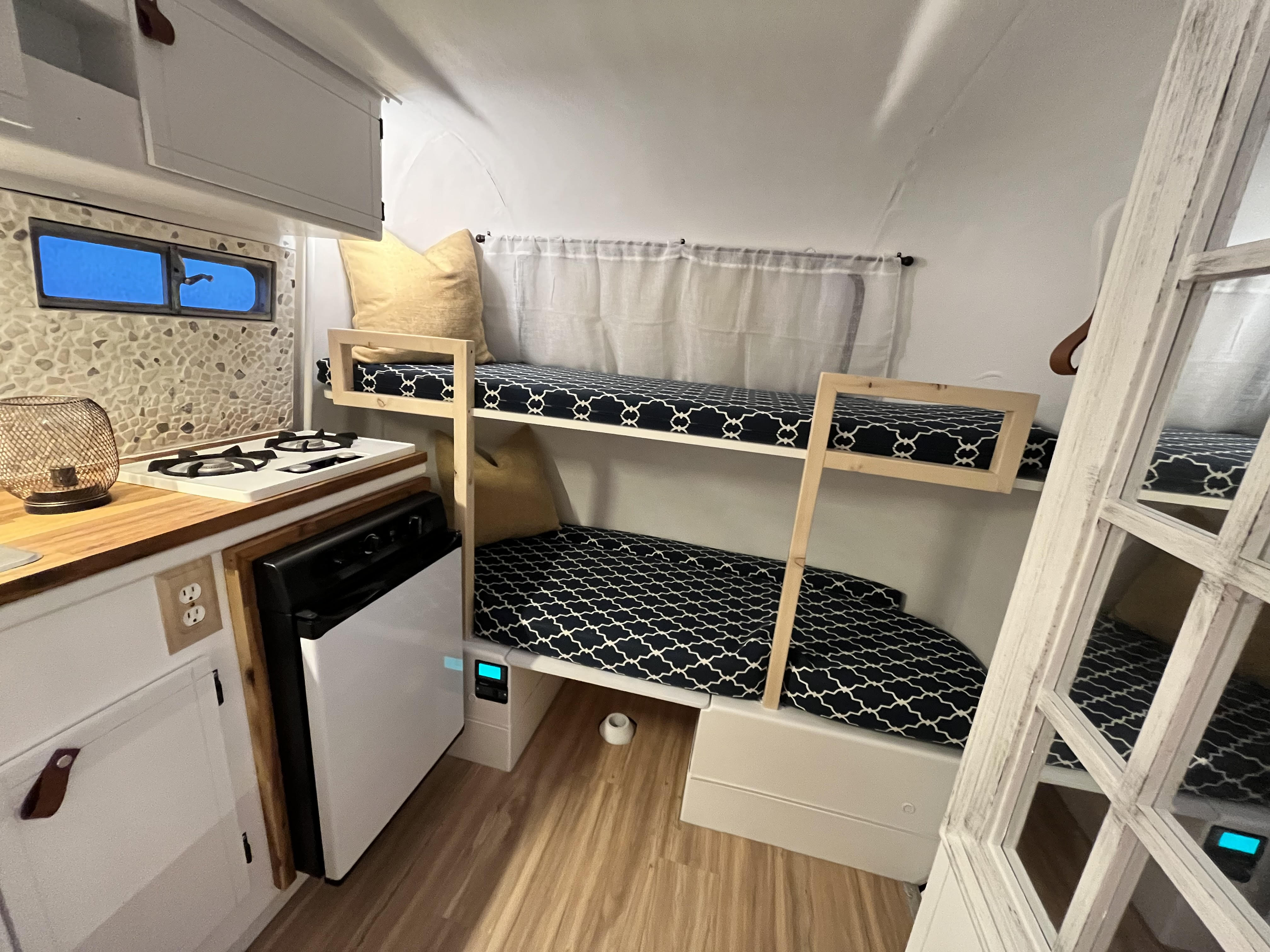 This RV rental features cozy bunk beds and a compact kitchen, perfect for adventurers.. Boler 1300 1978