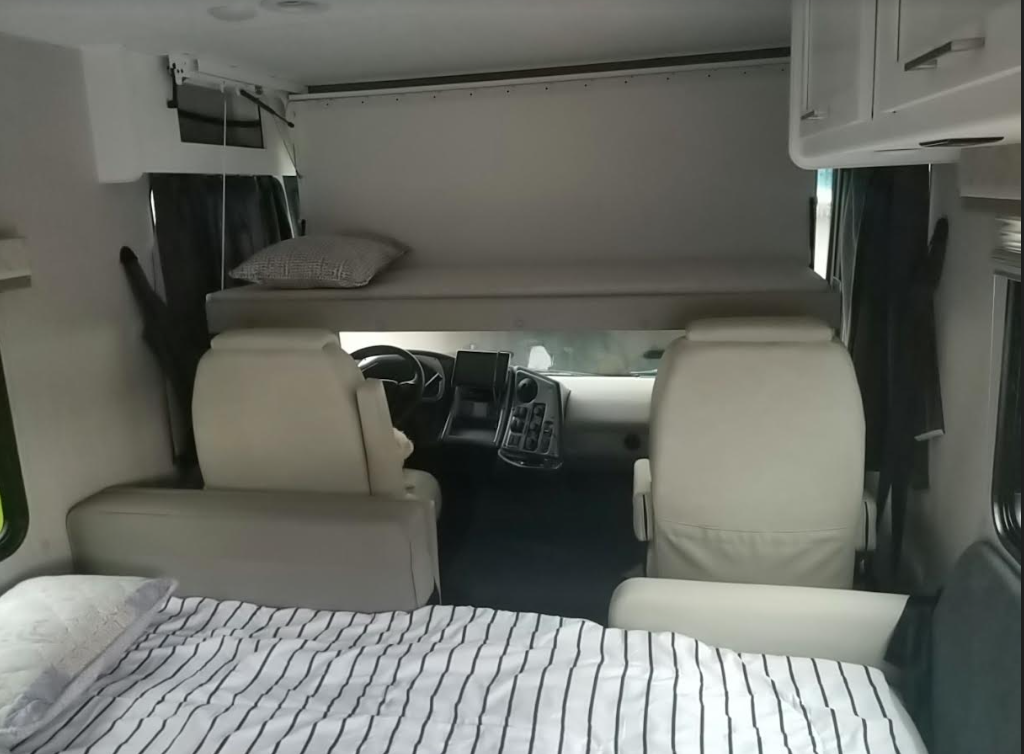 Overhead bunk bed over driver and dinette/sofa bed. Forest River Coachmen Pursuit 2022