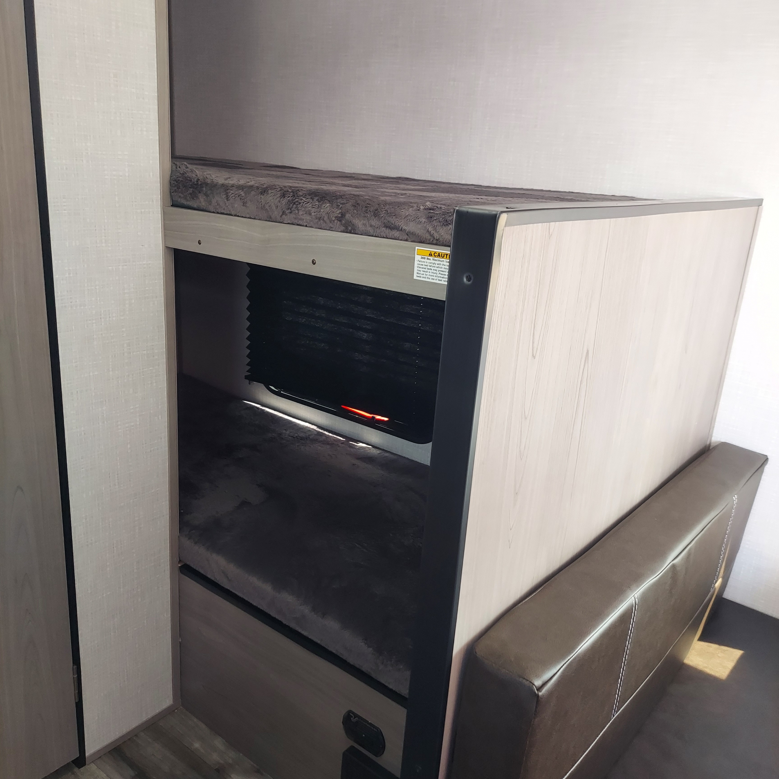 RV rental interior featuring cozy bunk beds with plush mattresses and an adjacent seating area. Perfect for families.. Dutchmen Coleman Lantern LT 2023