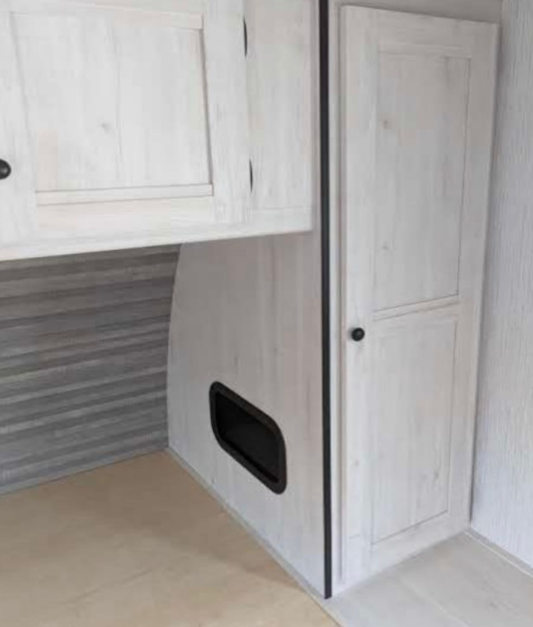 Light wood cabinets & storage in a compact RV rental interior, including a lower bunk and wardrobe. Ideal for travel.. Heartland RVs Trail Runner 2023
