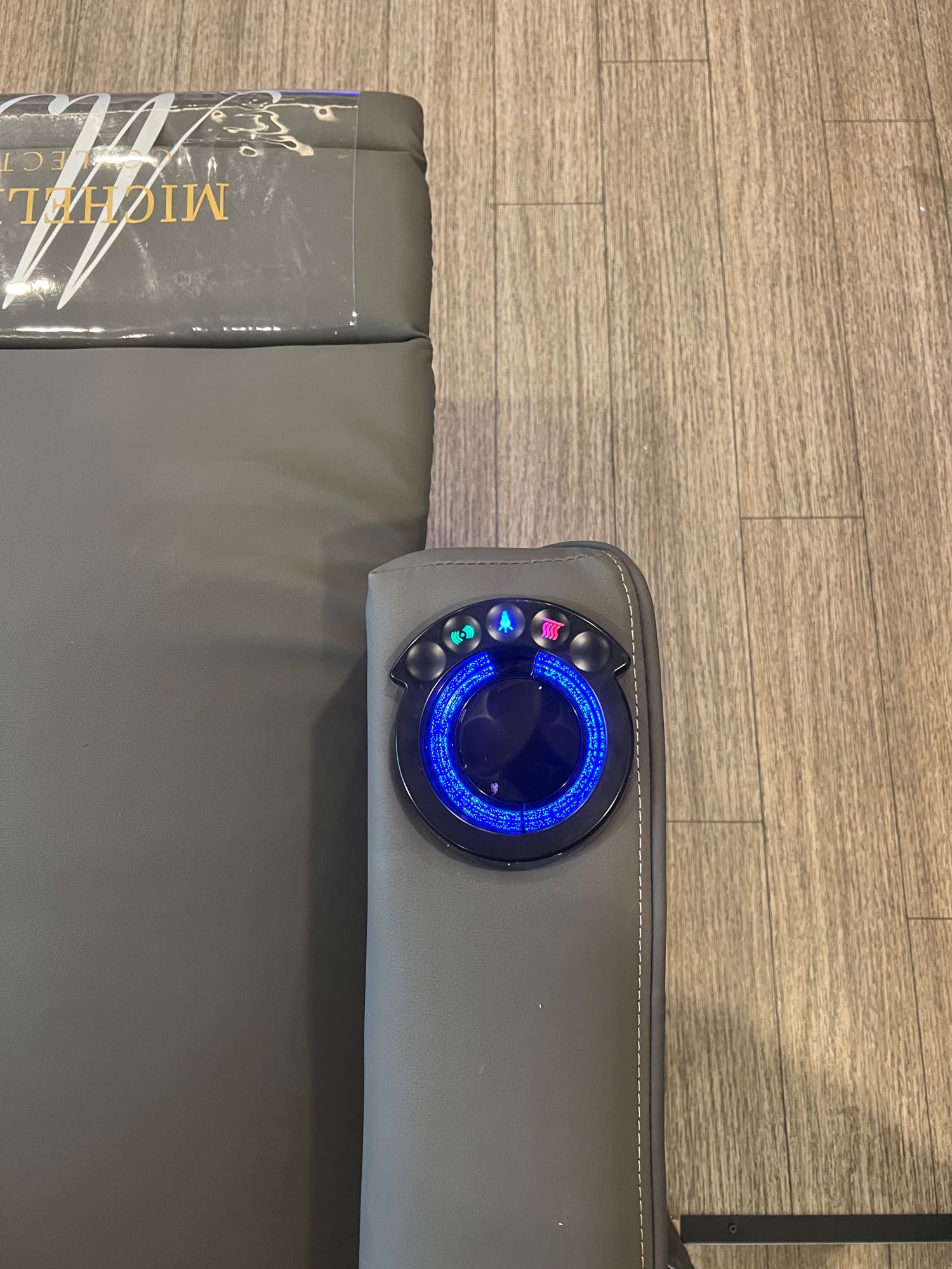 Enjoy luxurious comfort in your RV rental with this gray seat's armrest, featuring illuminated cup holder, heat, and recline controls.. Forest River Sabre 37FLL 2023