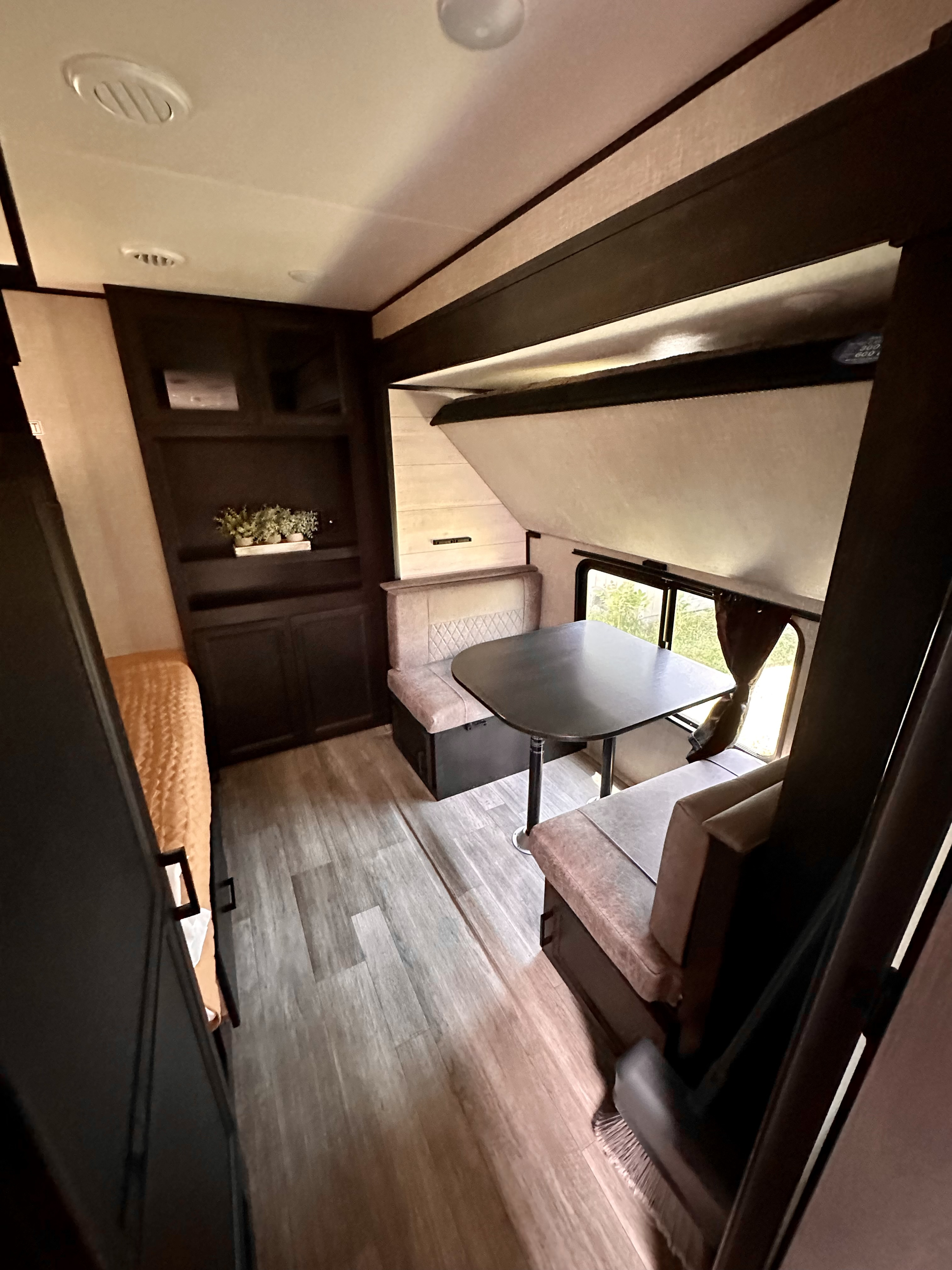 Spacious RV rental interior with a convertible dinette, lounge, and drop-down bunk bed, ideal for your travels.. Jayco Jay Flight 2022