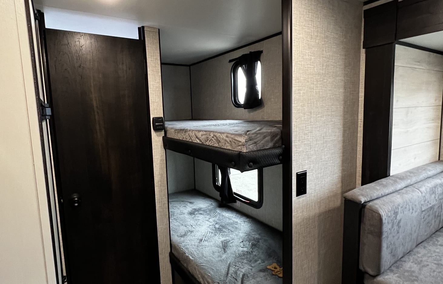 Cozy RV rental interior with bunk beds, perfect for family adventures. Features comfortable sleeping areas and a compact design.. Jayco Jay Flight SLX Baja Edition 2022