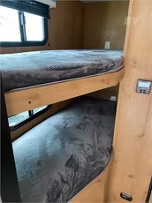 RV rental interior. Two cozy bunk beds with windows, perfect for extra sleeping capacity in your RV adventure.. Riverside RV Retro 190BH 2023