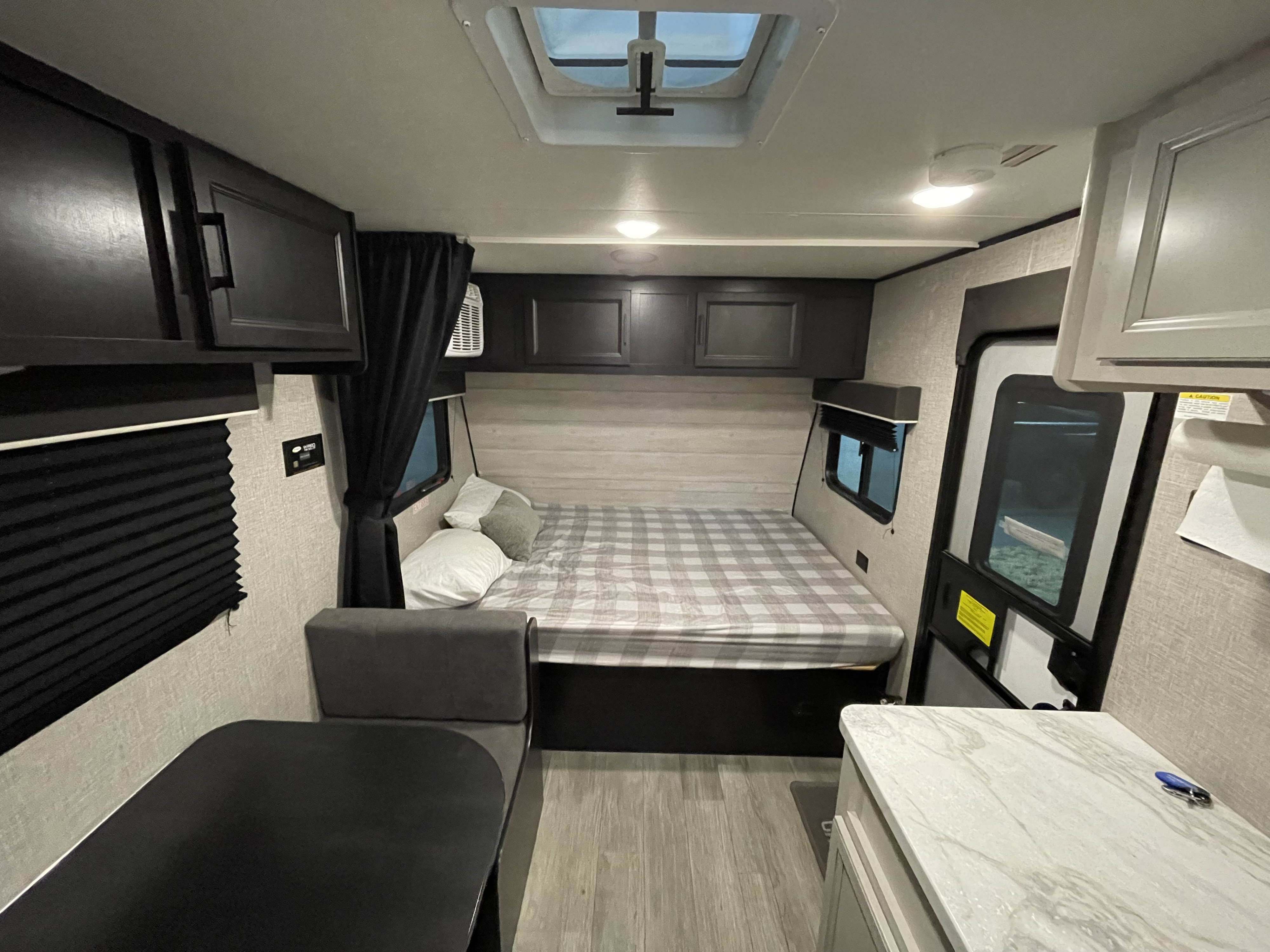 Relax in this RV rental's tan recliner and passenger seat, featuring wood flooring and a safety fire extinguisher.. Jayco Jay Flight SLX 2022