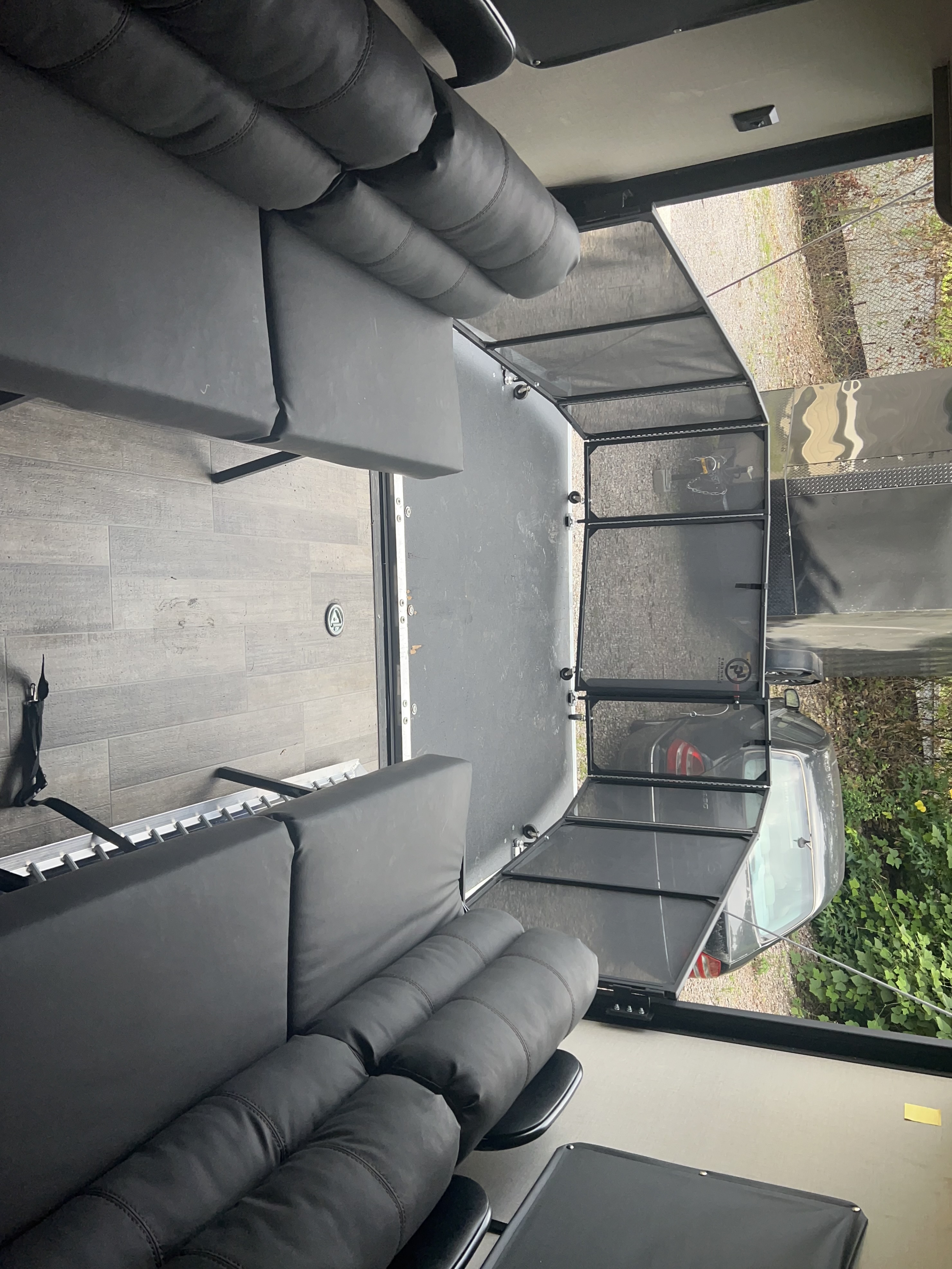 Experience a versatile RV rental interior. This toy hauler offers comfortable black seating & durable flooring with a rear ramp.. Coachmen Catalina 2021