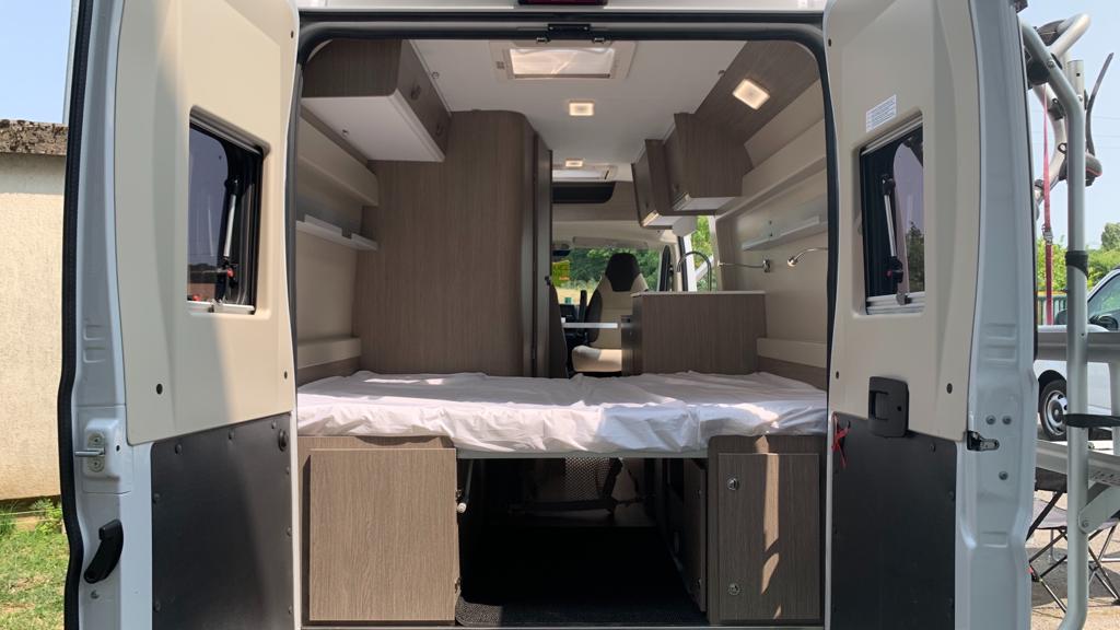 Spacious RV rental interior: camper van with comfortable bed, kitchen, and living area, ready for your adventure.. RollerTeam Livingstone 5 Sport 2023