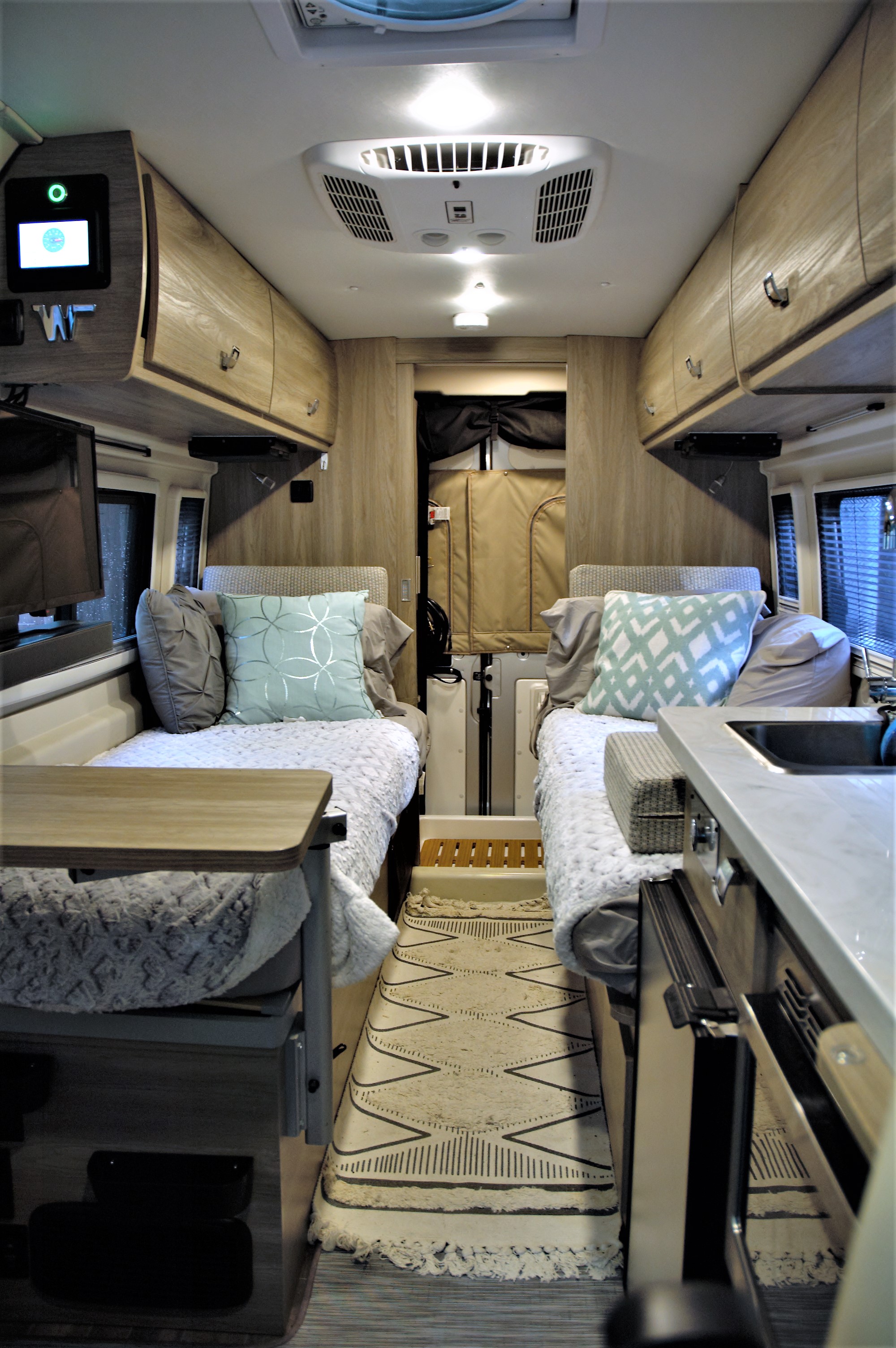 View from the kitchen to the sleeping/entertaining quarters. . Winnebago Travato 2022
