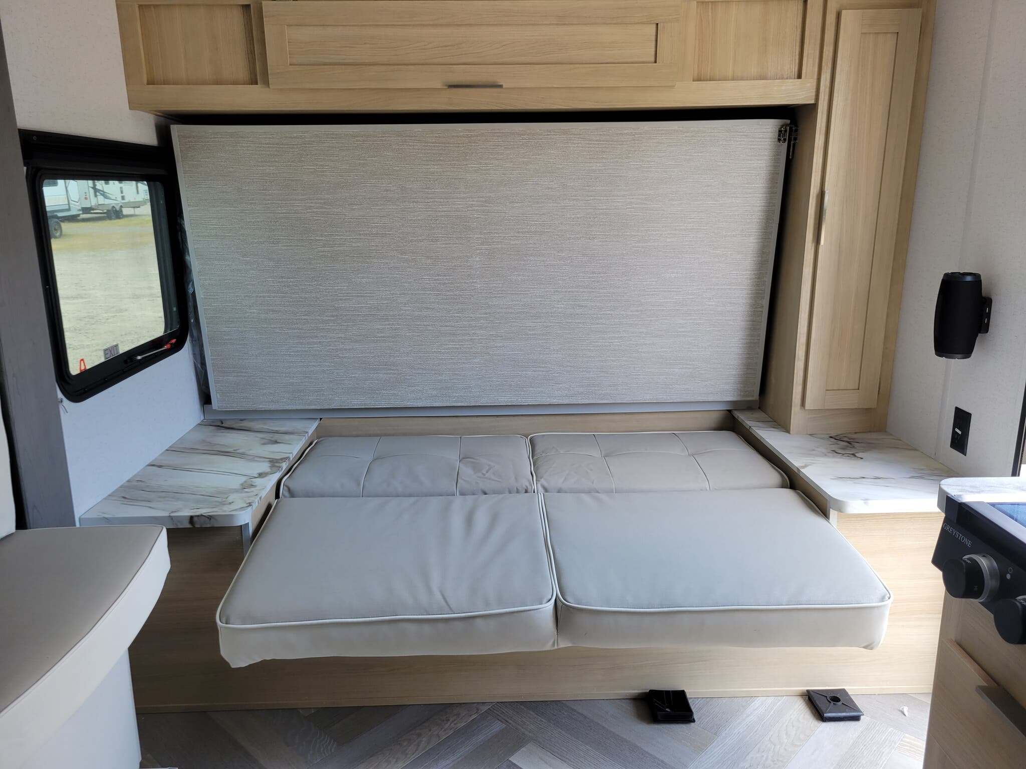 RV rental: Convertible sofa bed, light wood cabinets, and marble-look side tables in a compact, efficient interior.. Forest River Salem FSX 2023