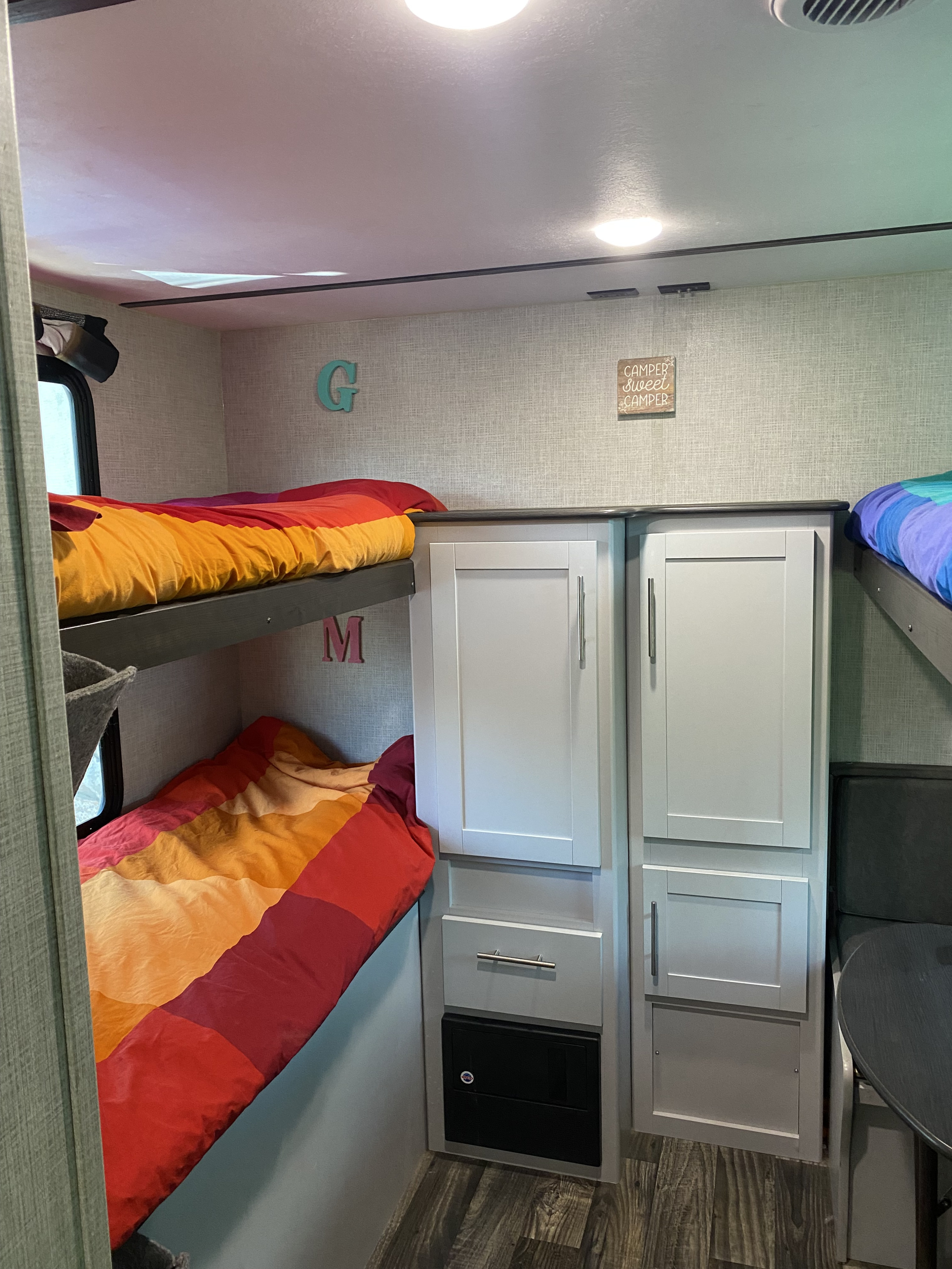 Family-friendly RV rental interior with bunk beds, compact storage, and cozy decor.. Keystone RV Bullet Ultra Lite 2019