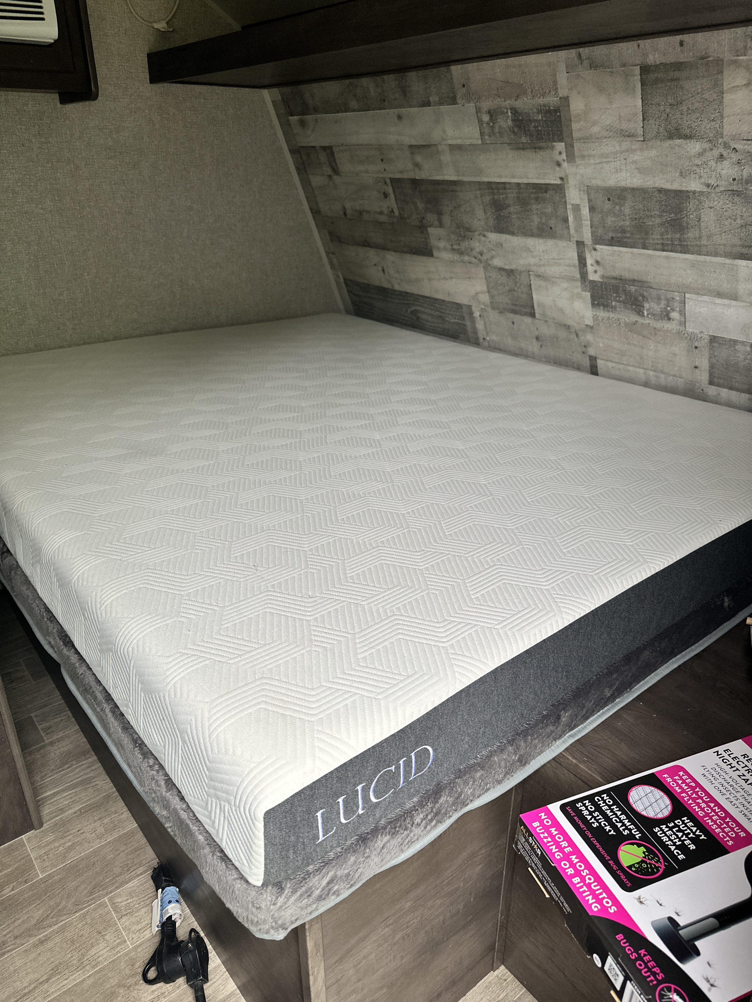 A white Lucid mattress in an RV rental bedroom, offering a comfortable space for travelers.. Dutchmen Coleman Lantern LT 2020