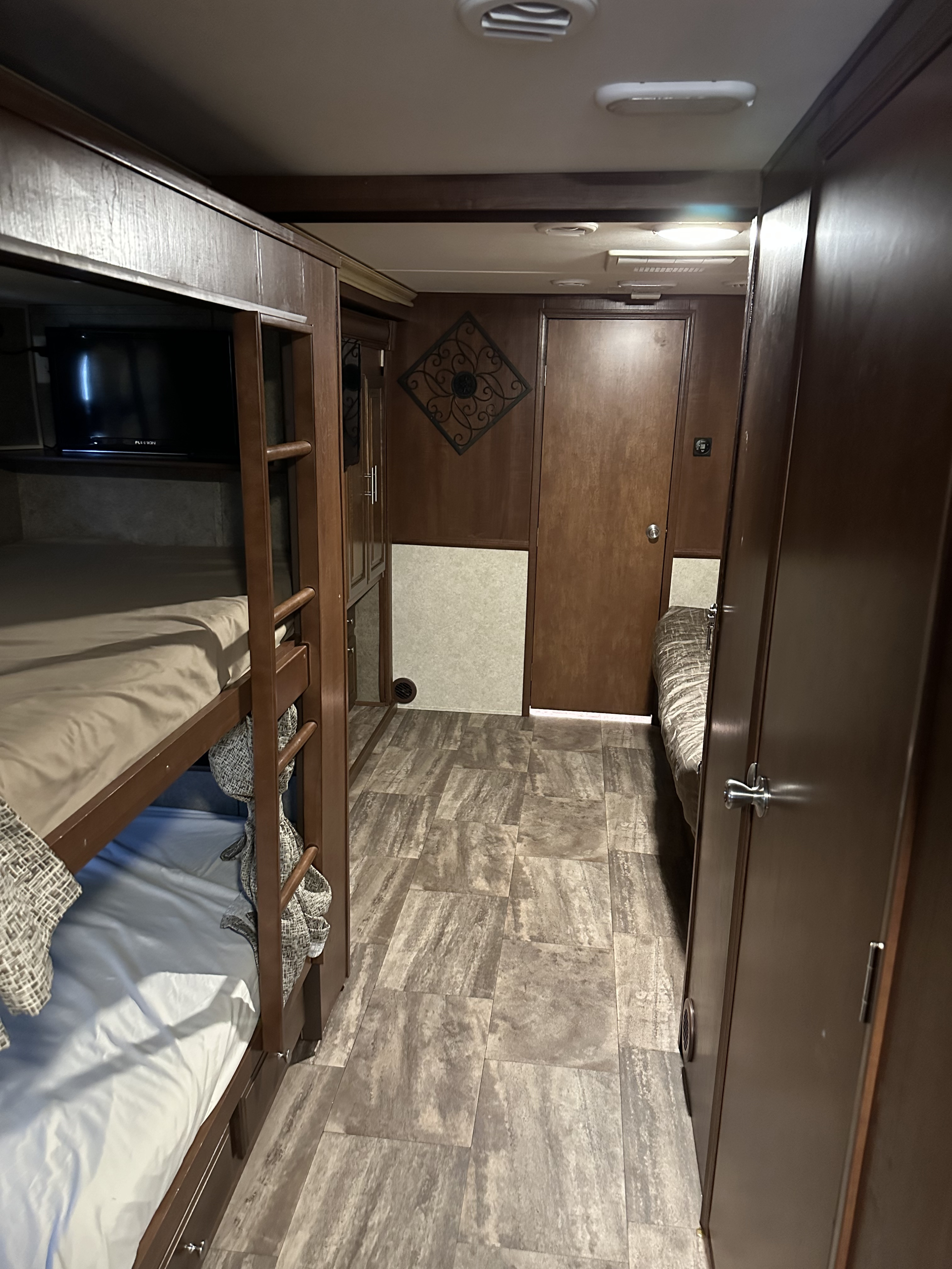 Experience comfort in this RV rental's interior, boasting bunk beds, a TV, and a private bedroom area.. Georgetown 364TSF 2017