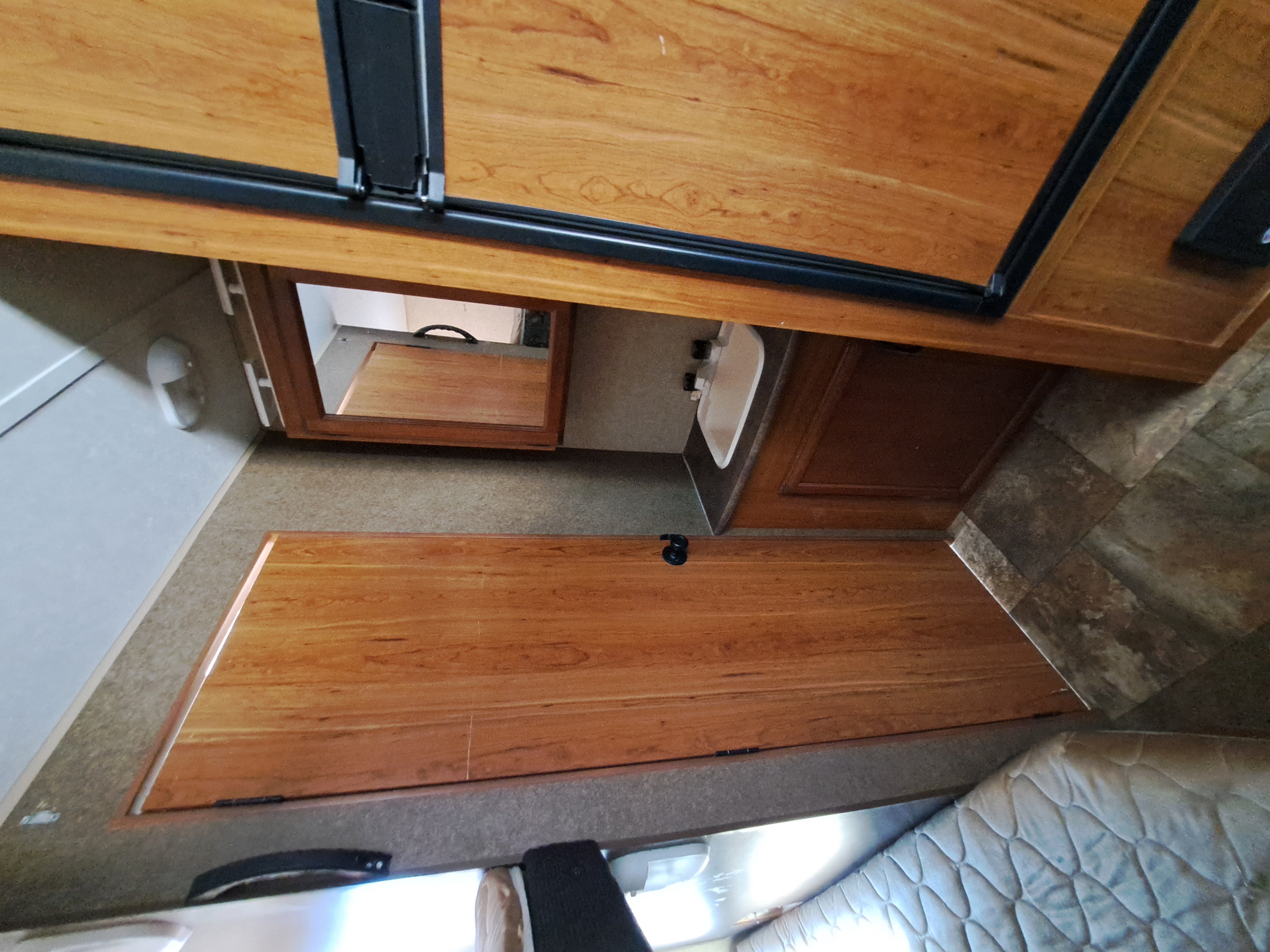 Experience comfort in this rv rental. Overhead view highlights wooden cabinetry, compact bathroom with sink, and cozy bed.. Starcraft AR-One Maxx 2015